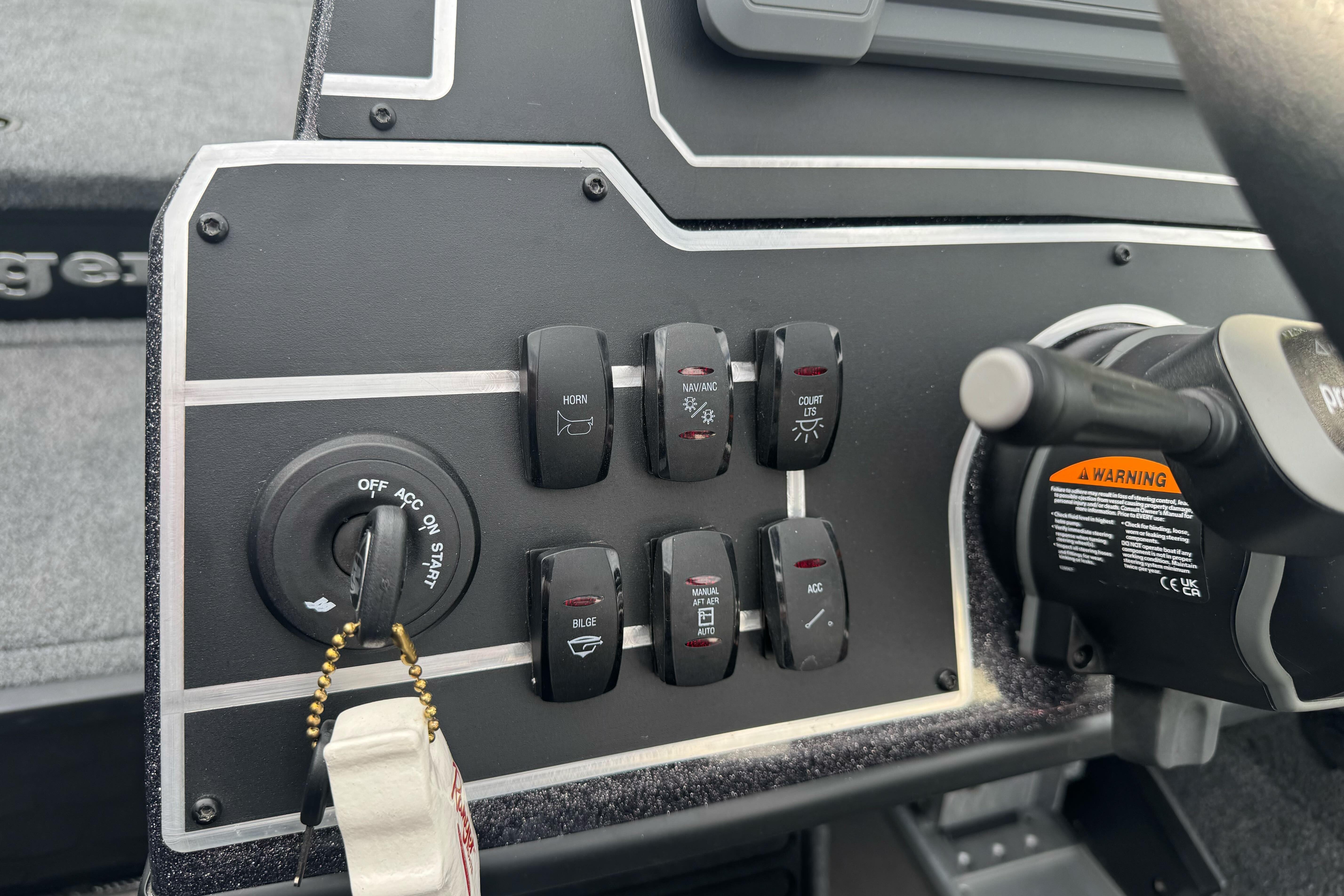 Control panel of 2026 Ranger ALPHA 208 boat with switches and ignition key.