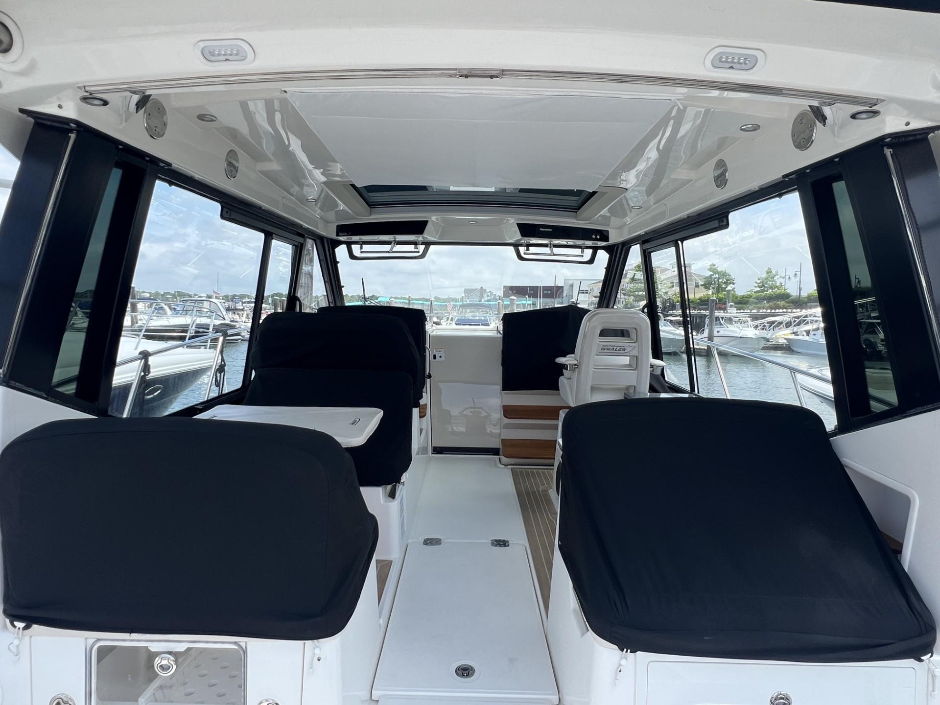 Interior view of 2021 Boston Whaler 405 Conquest boat, featuring spacious seating and modern design.