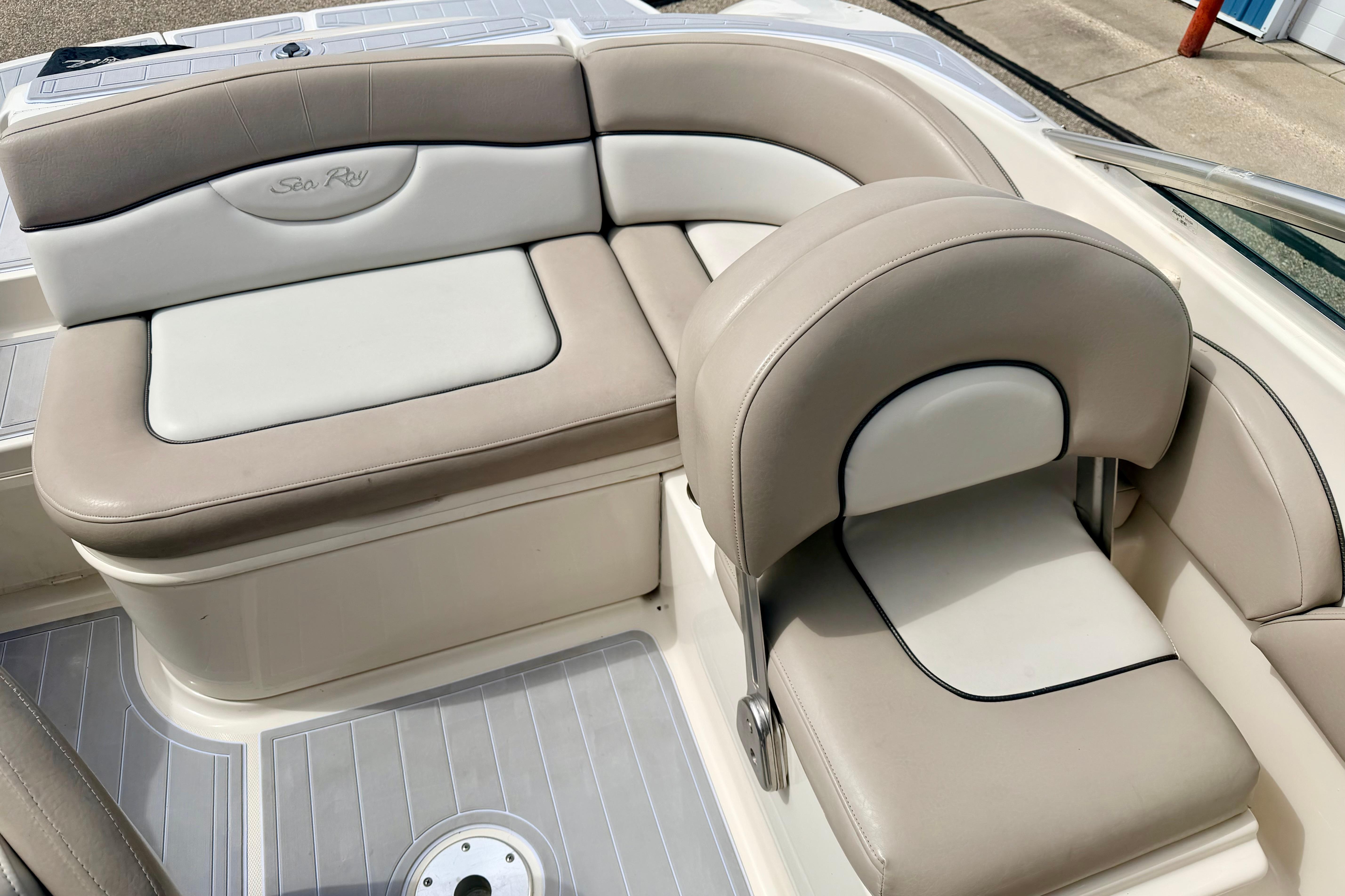 2003 Sea Ray 200 Sundeck boat interior with beige and white seating.