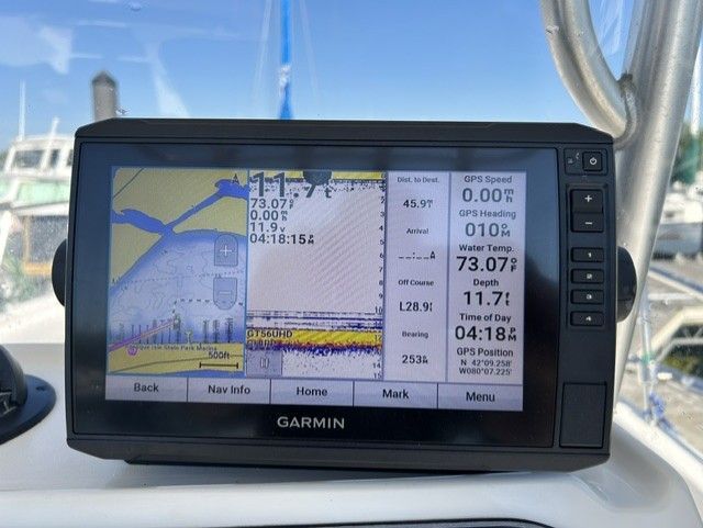 A Garmin navigation system displays maps and data on a boat.