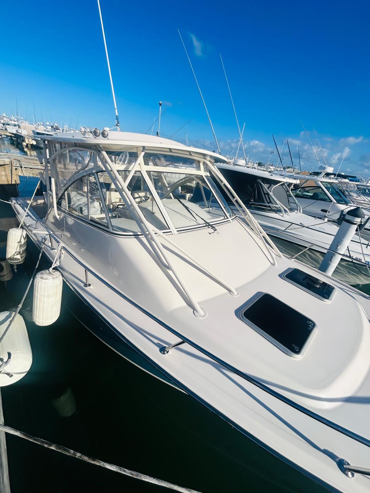 2021 Grady-White Express 330 boat docked in marina under clear blue sky.