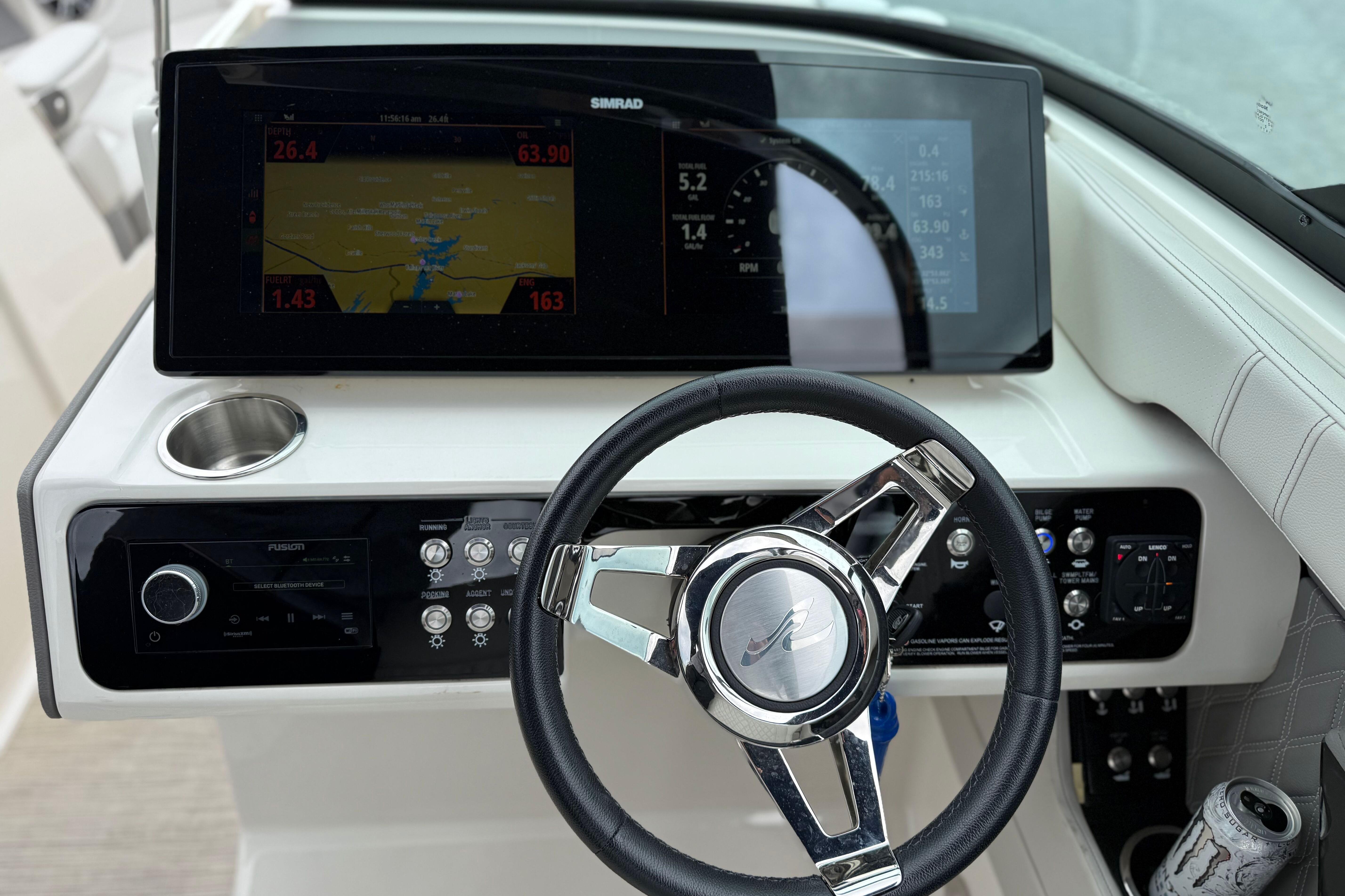 2022 Sea Ray SLX 280 dashboard with steering wheel and navigation display.