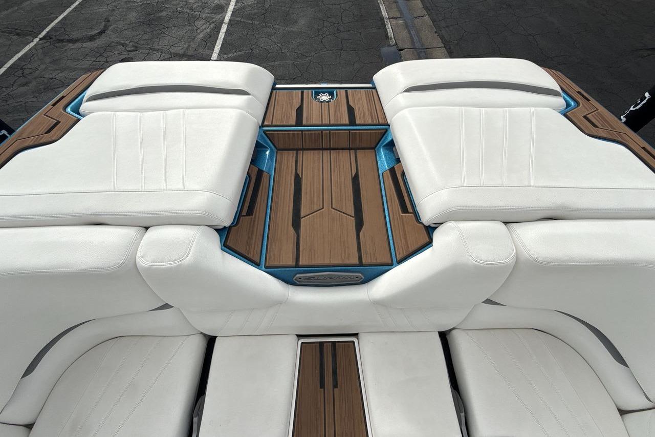 2024 Supra SA 550 boat interior with white seating and wood accents.