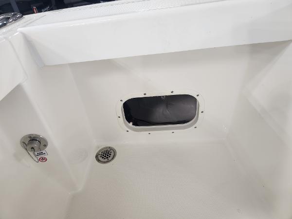 2025 Pathfinder 2400 Open boat interior with drain and access hatch.