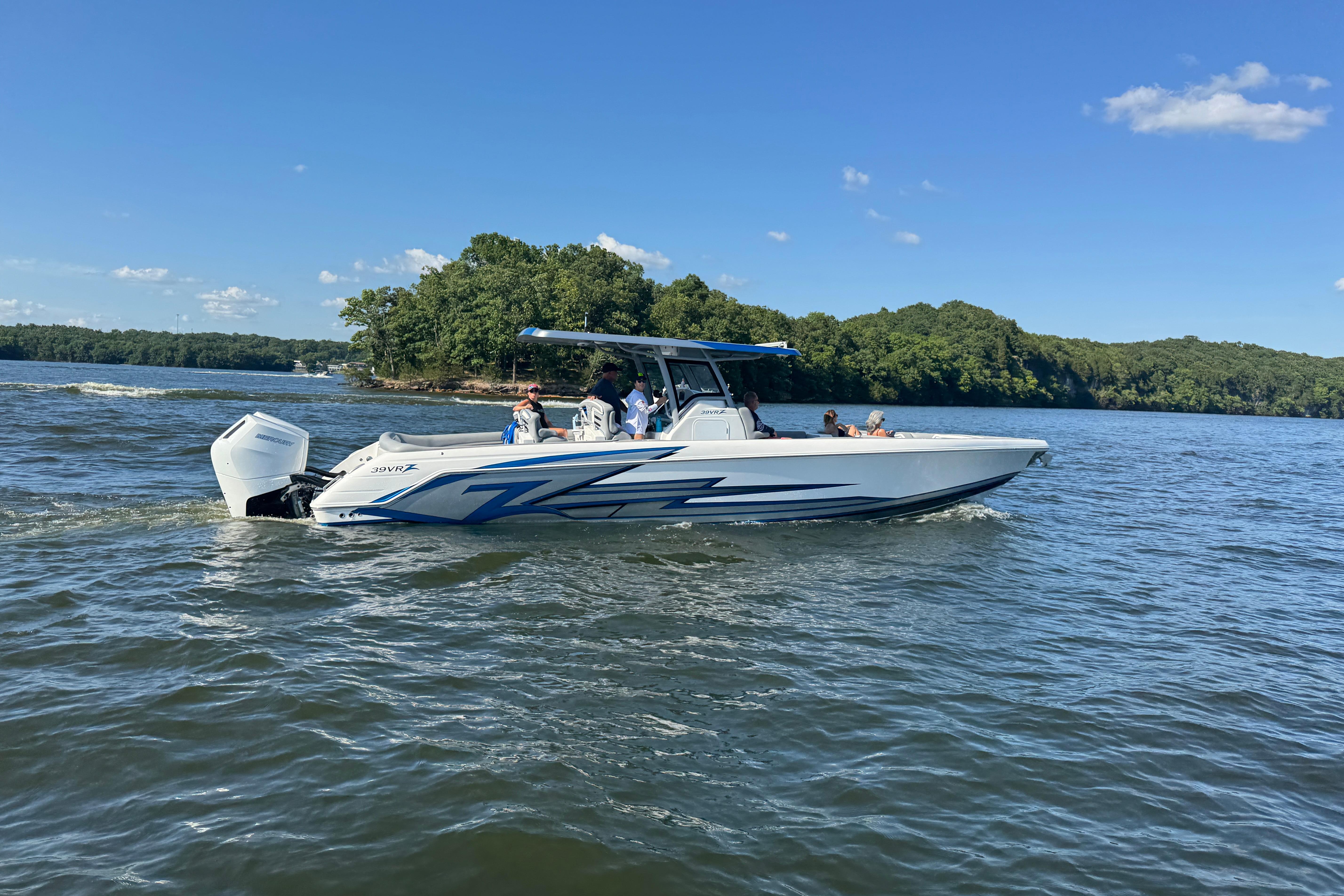2024 Donzi 39 VRZ boat cruising on a lake under a clear blue sky.