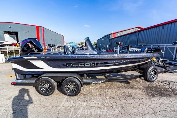 2024 Recon 985 SC boat on a trailer in a marina.