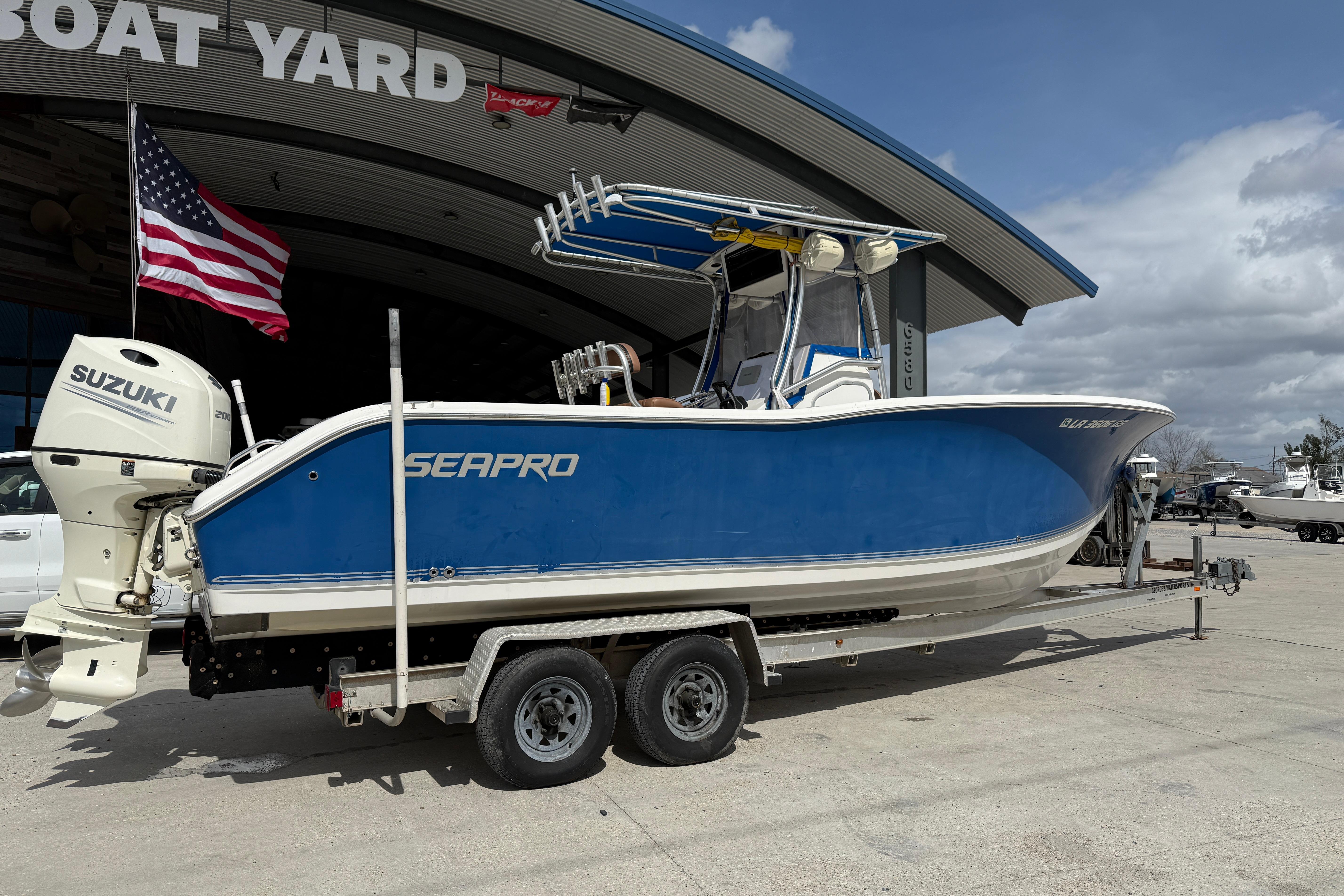 2007 Sea Pro 270 Center Console boat on trailer, parked at boat yard.