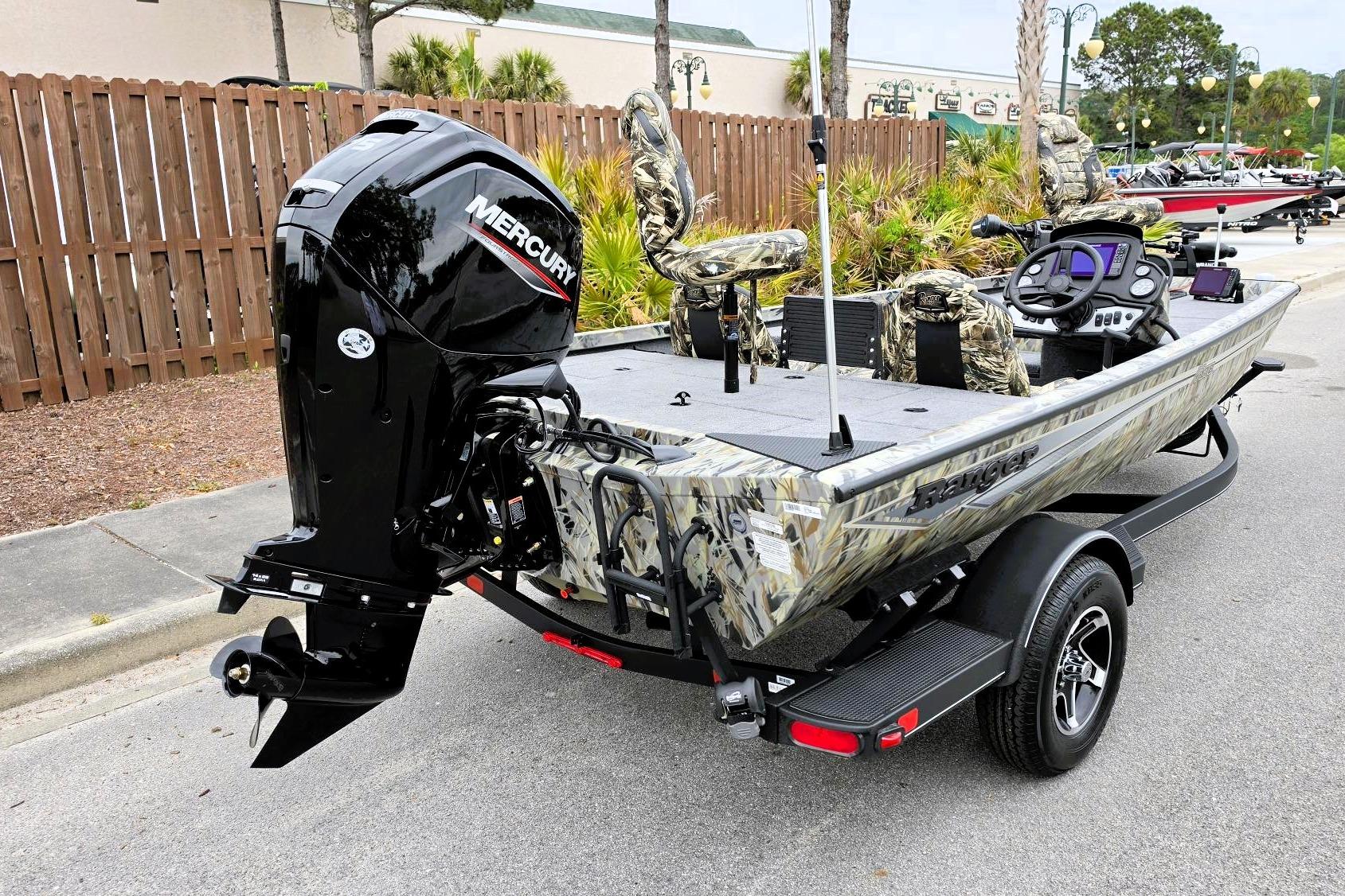 2026 Ranger RT178 boat with Mercury engine, camo seats, and trailer parked outdoors.