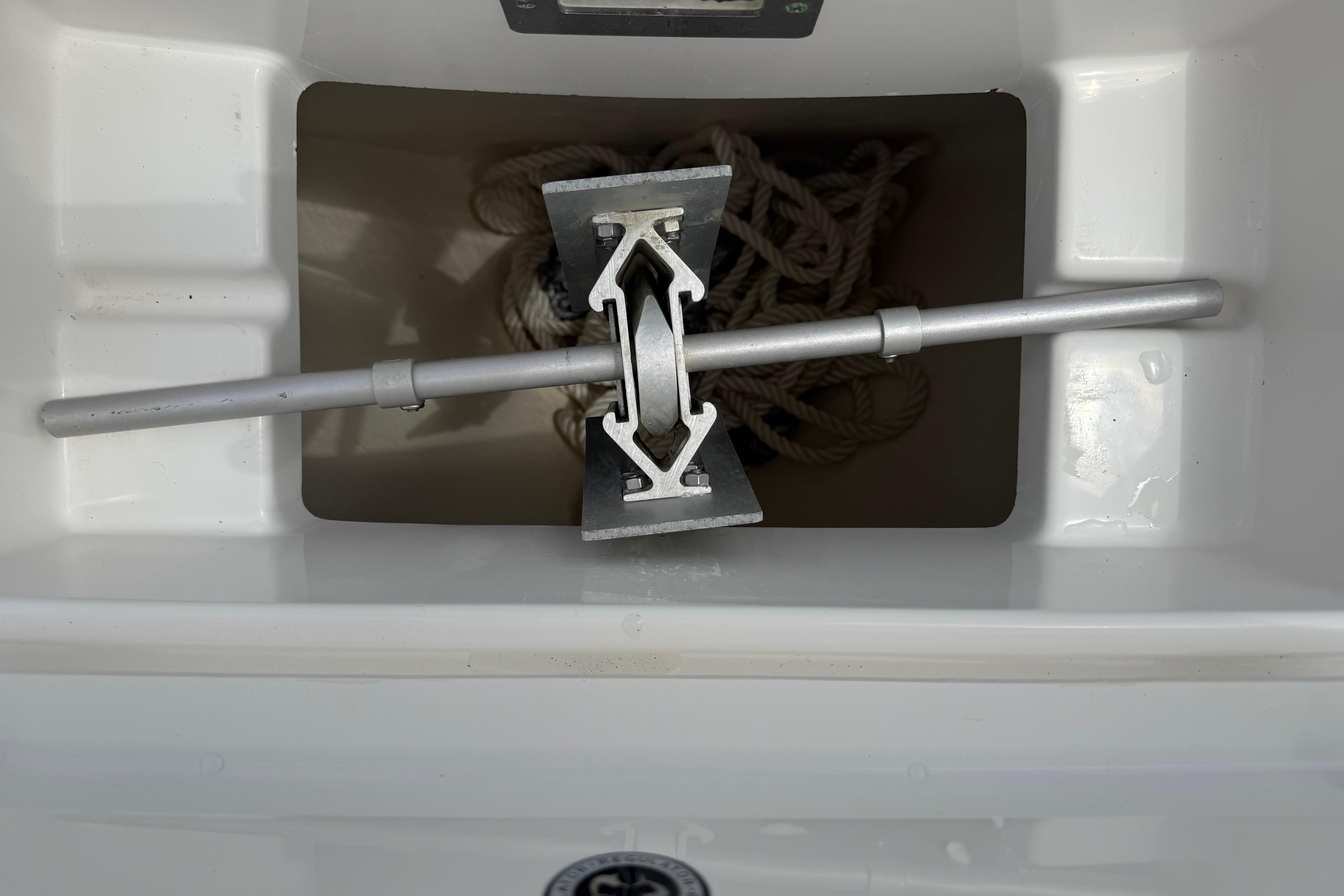 Anchor storage compartment on a 2019 Regulator 26XO boat, featuring a neatly coiled rope.