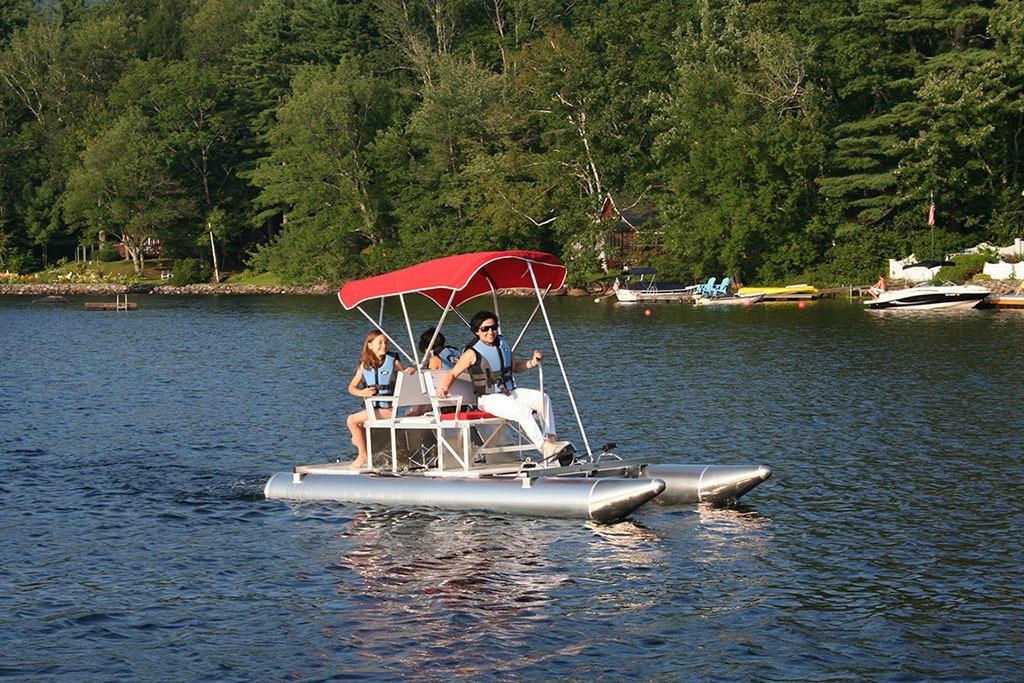 Two people enjoying a ride on a 2026 Aqua Cycle 2 pedal boat.