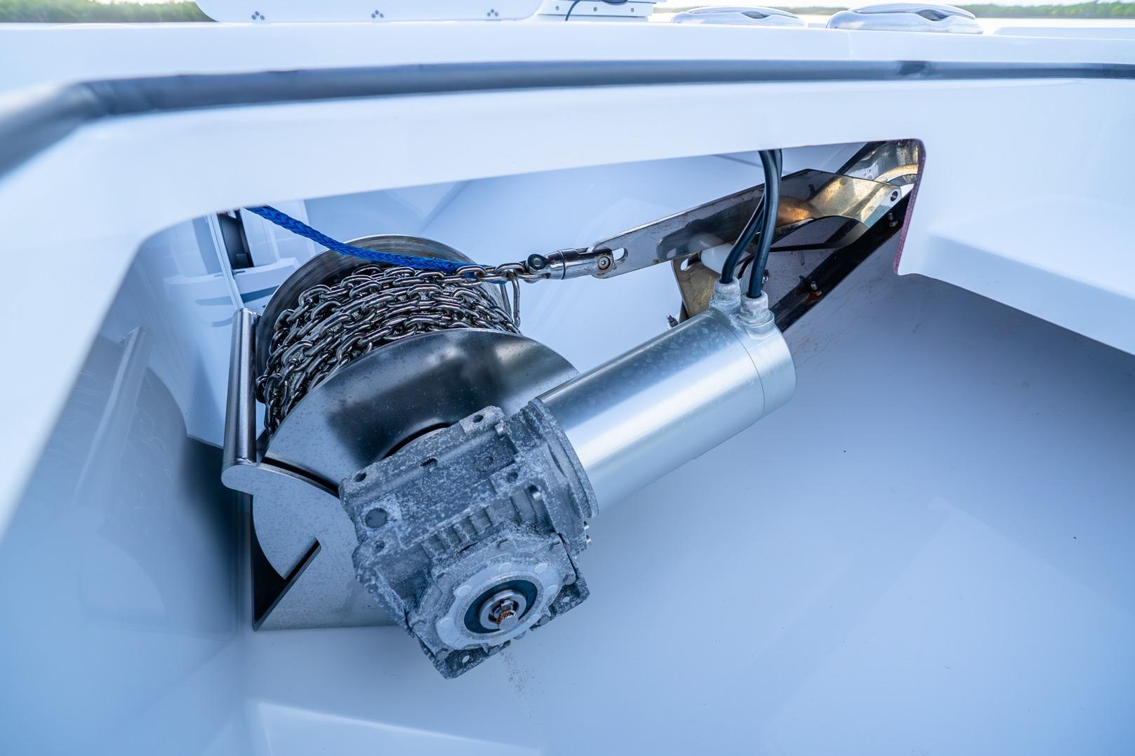 Anchor winch system on a 2025 Freeman 43 boat, showcasing chain and motor components.