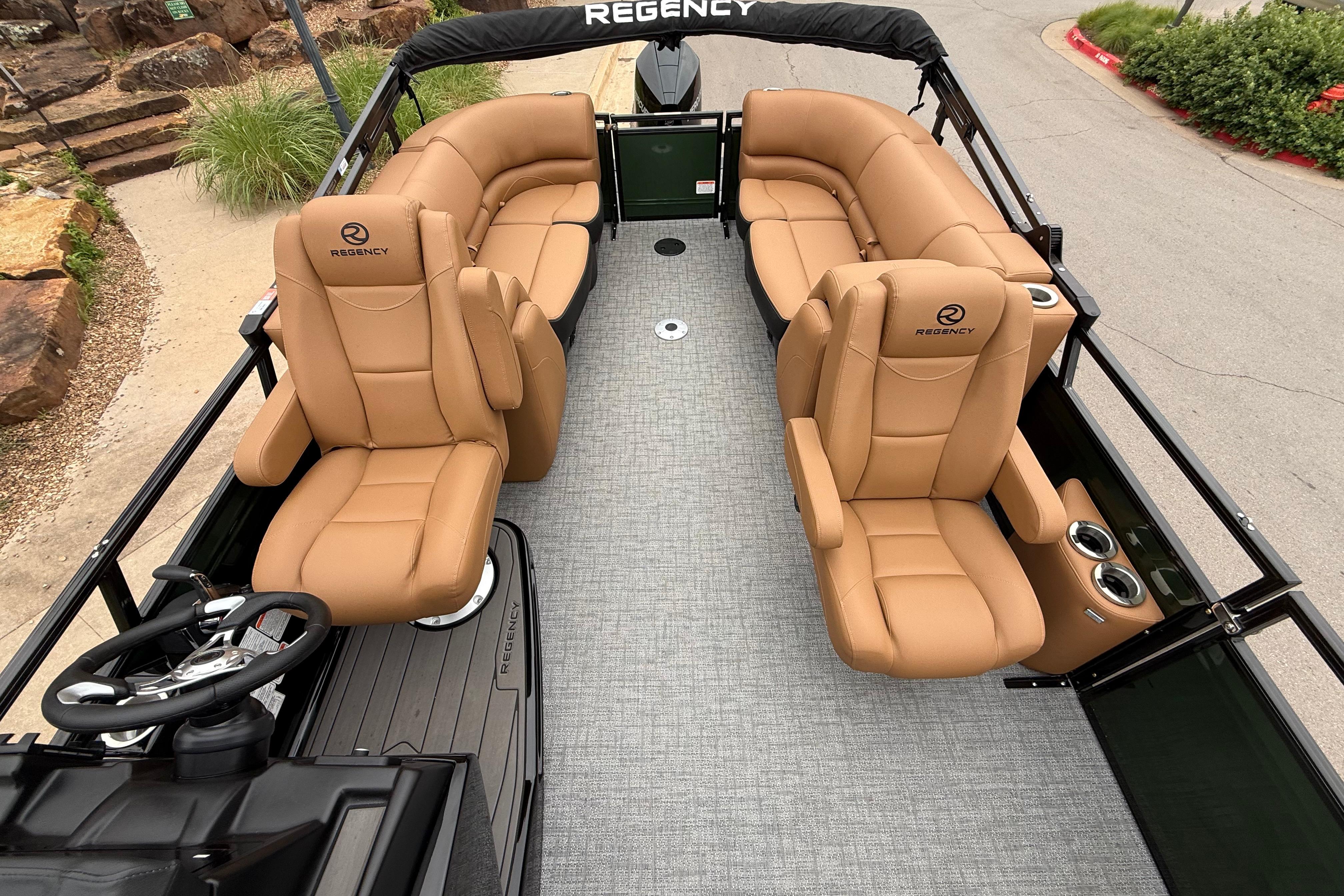 Luxurious 2026 Regency 250 DL pontoon boat with tan leather seating and modern design.
