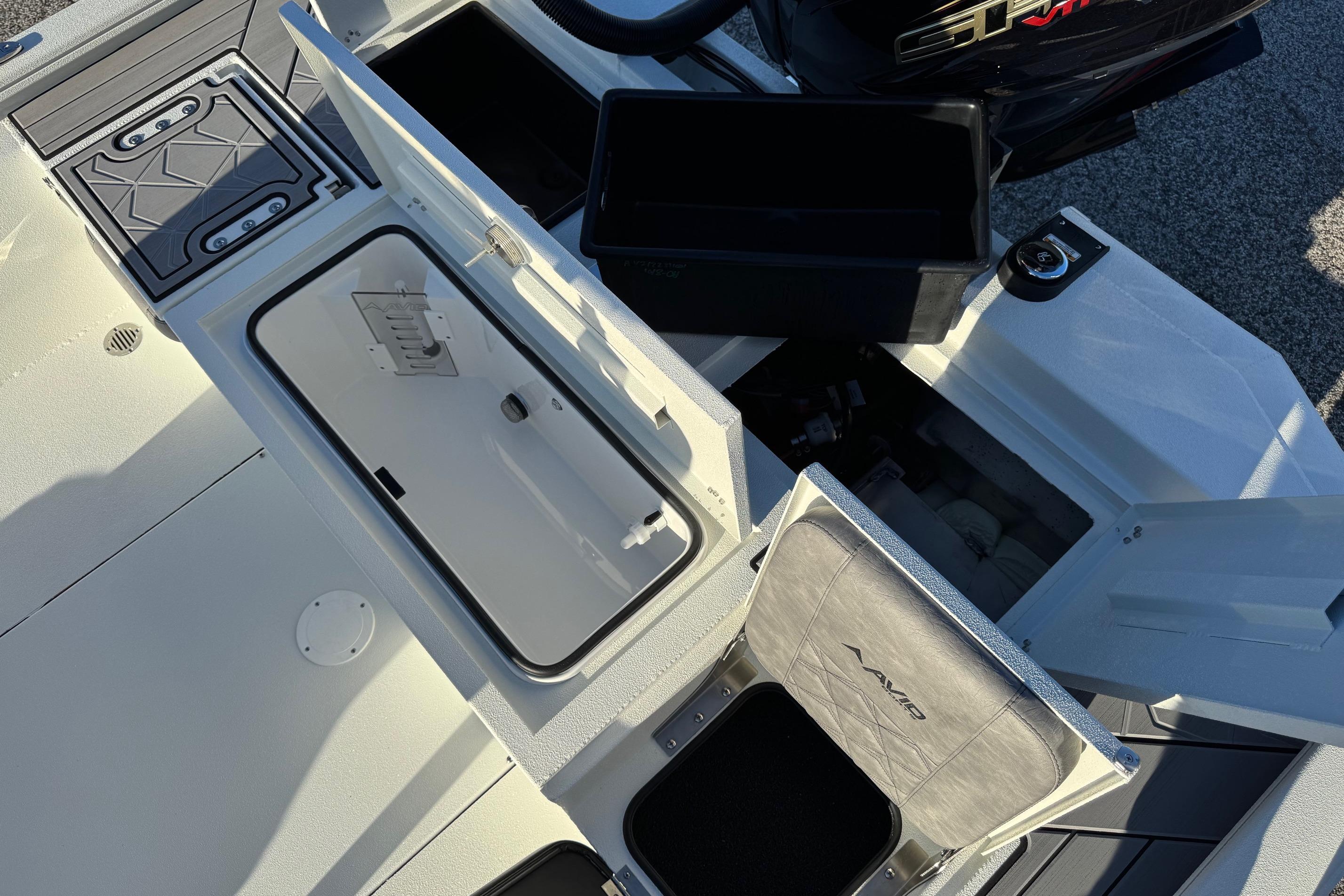 Avid 23 Mag 2025 boat interior with open storage compartments and seating.