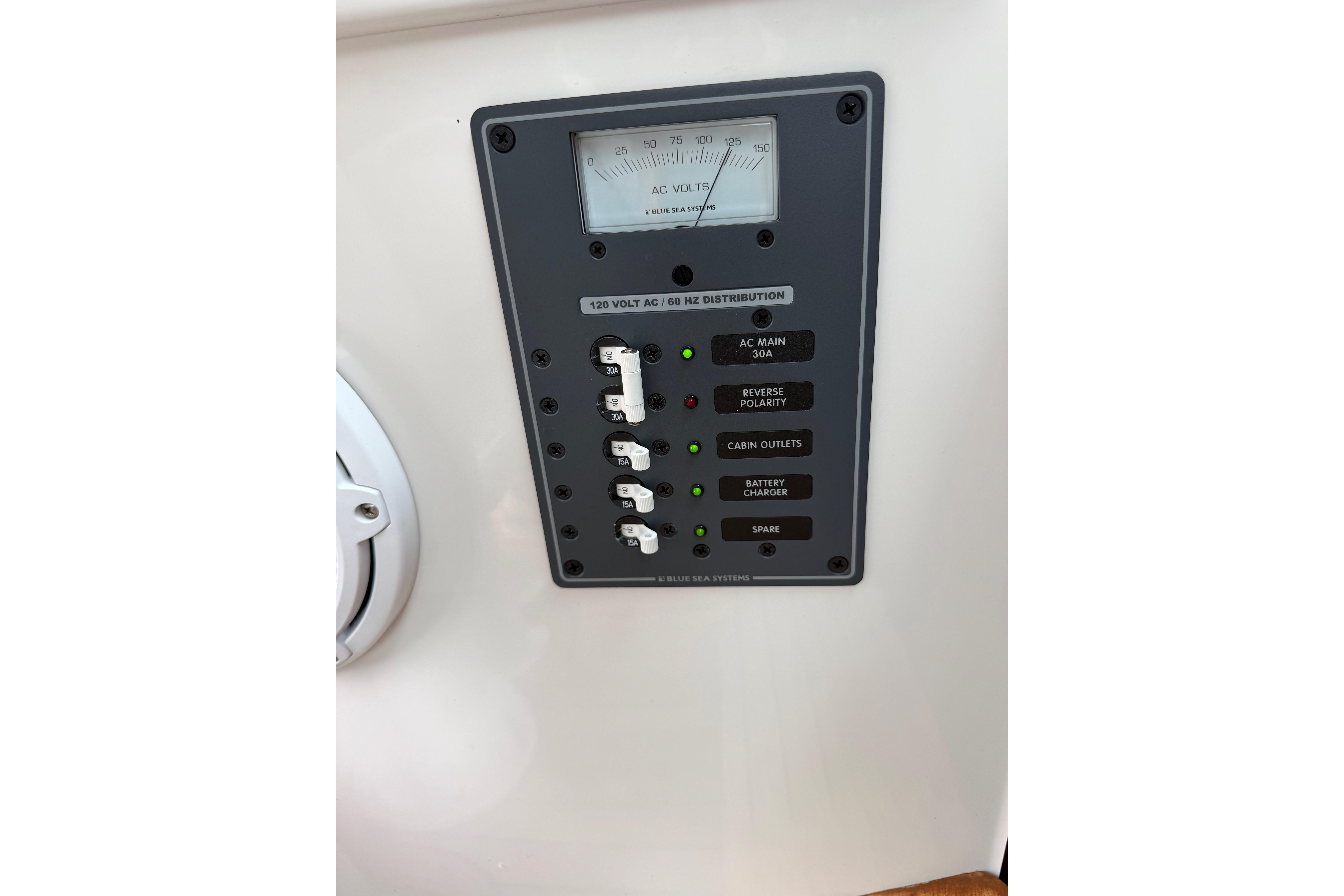 Electrical panel on a 2016 Protector Targa 30 boat, featuring AC voltage distribution.