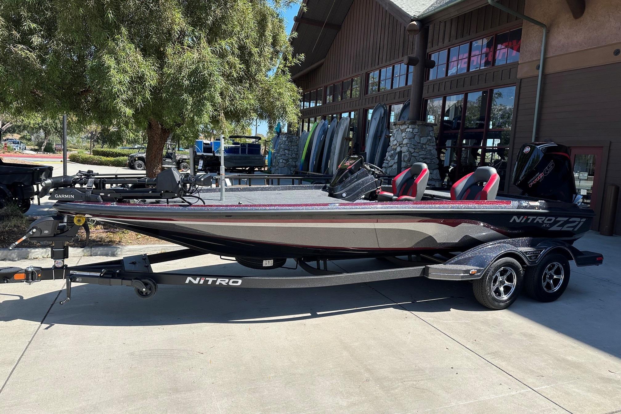 2026 Nitro Z21 XL Pro boat parked outside a building, showcasing sleek design and modern features.