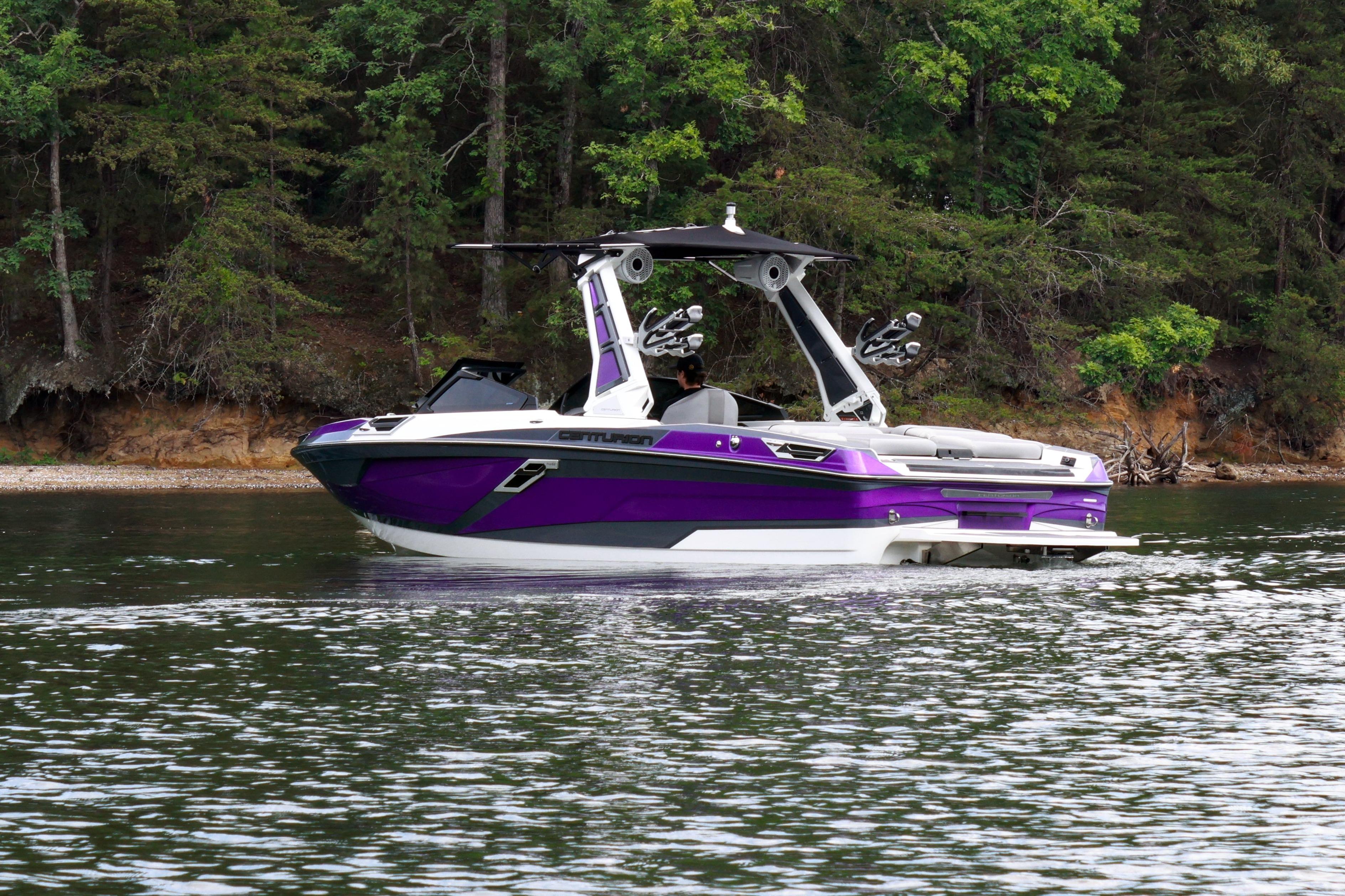 2022 Centurion Ri245 boat in vibrant purple on a serene lake.