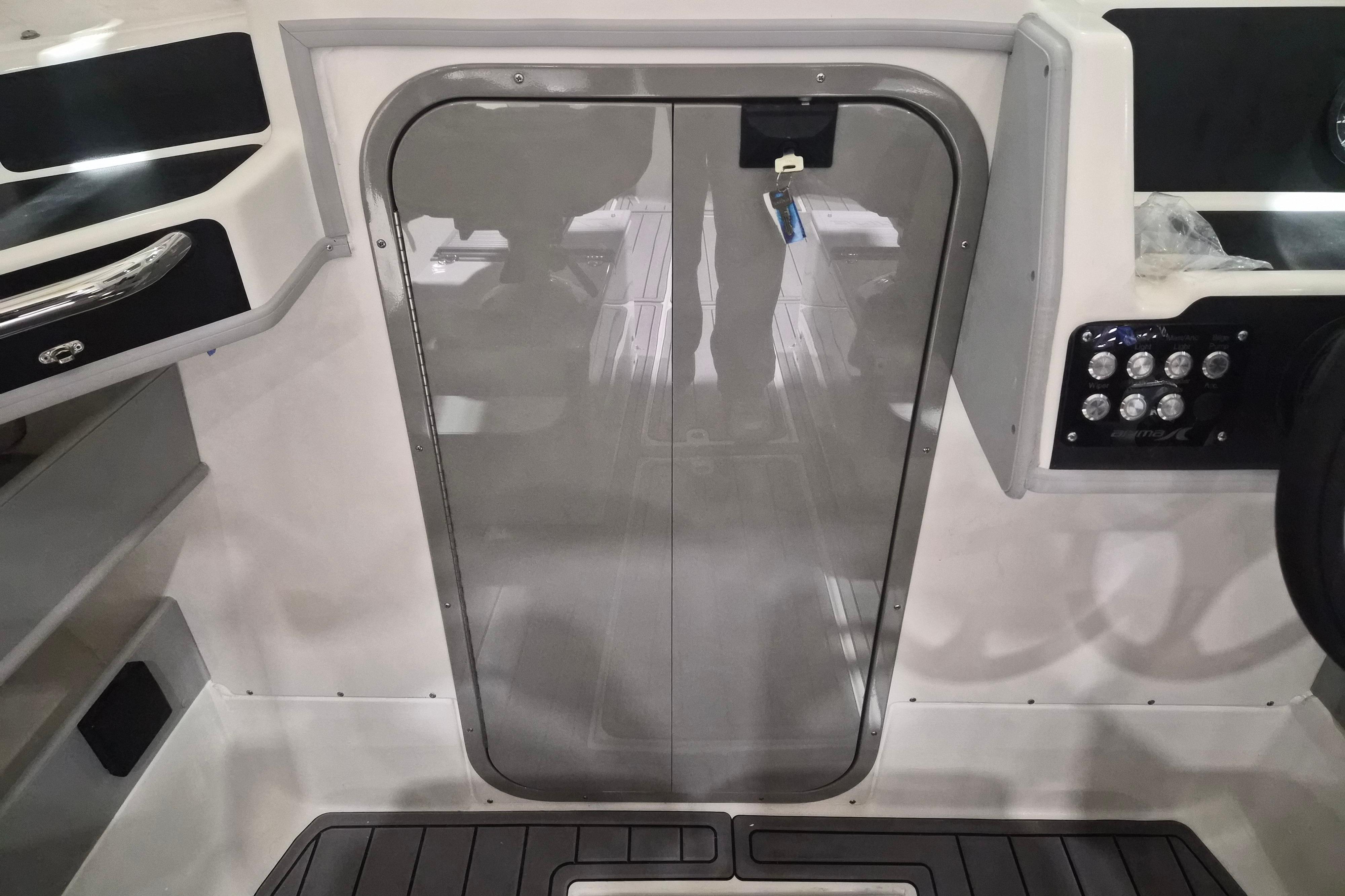 Interior view of 2026 Arima Sea Chaser 19 Yellowtail Edition boat, featuring sleek design and control panel.