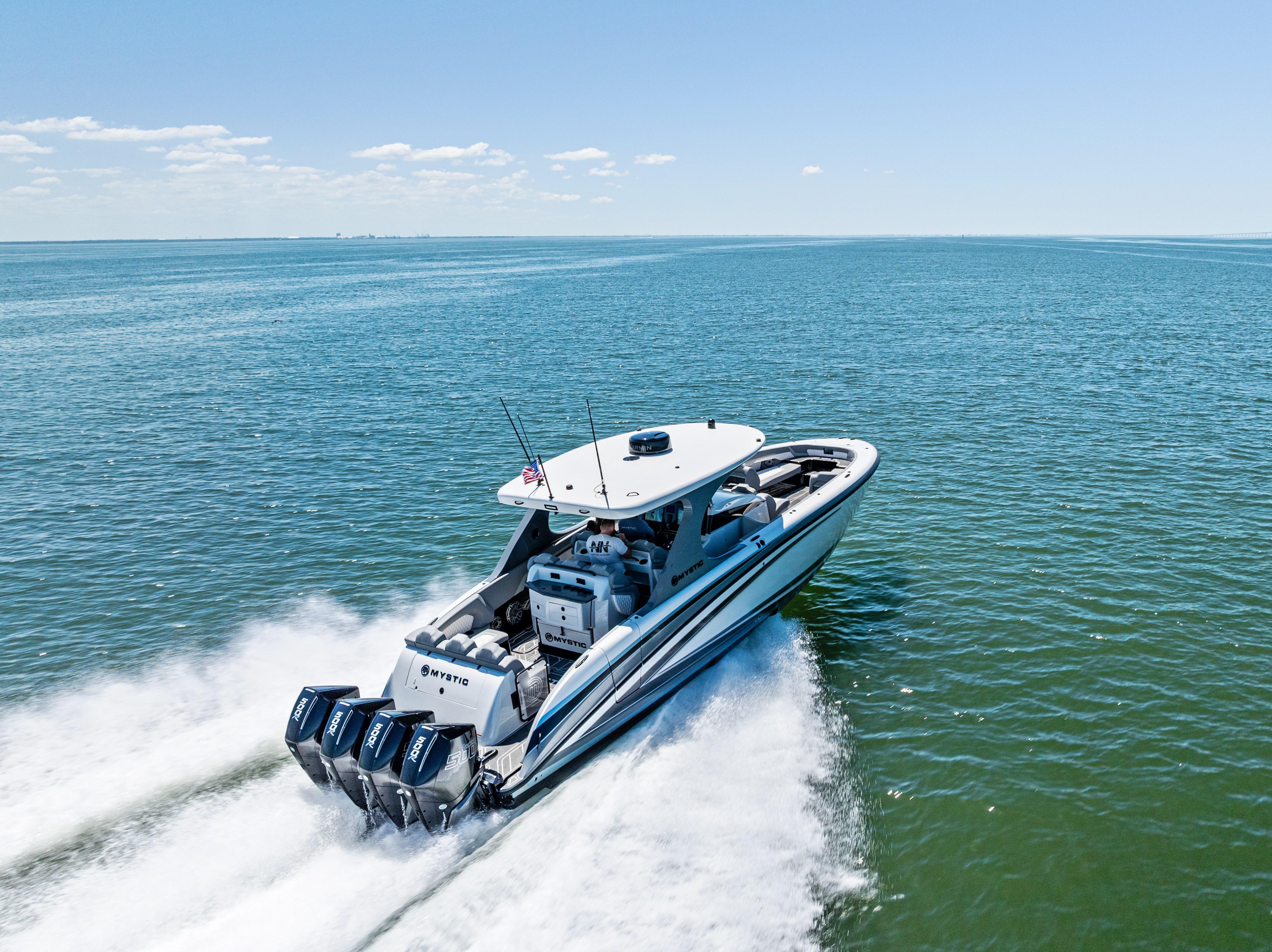 2026 Mystic Powerboats M4200 speeding on open water under clear skies.