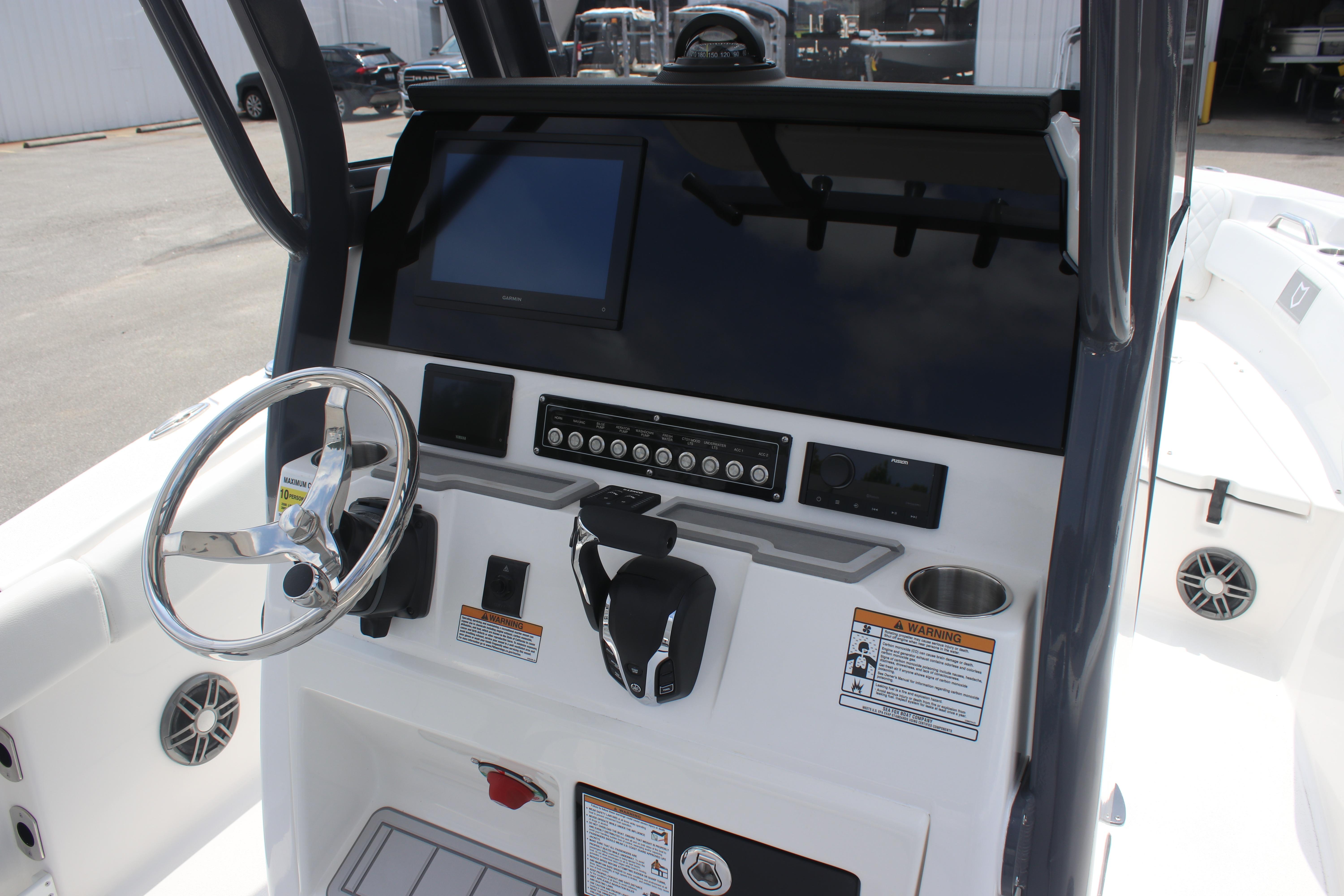 2026 Sea Fox 248 Commander boat dashboard with steering wheel and control panel.