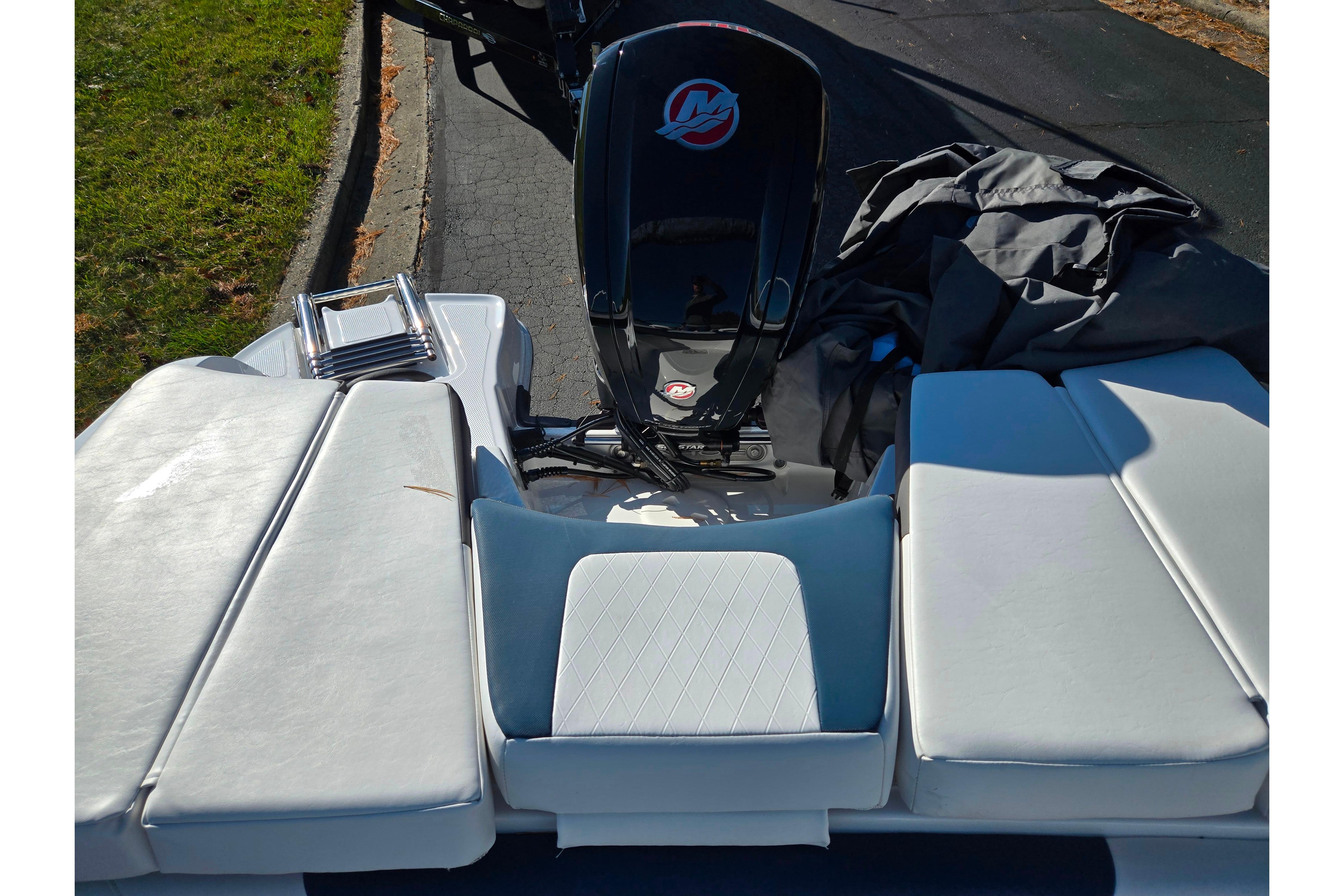 2023 Tahoe 185 S boat with cushioned seating and outboard motor.