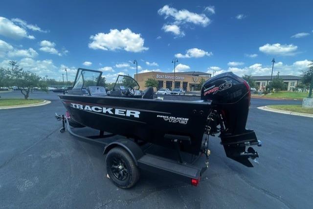 2026 Tracker Pro Guide V-175 Combo boat on trailer, parked outdoors under a blue sky.