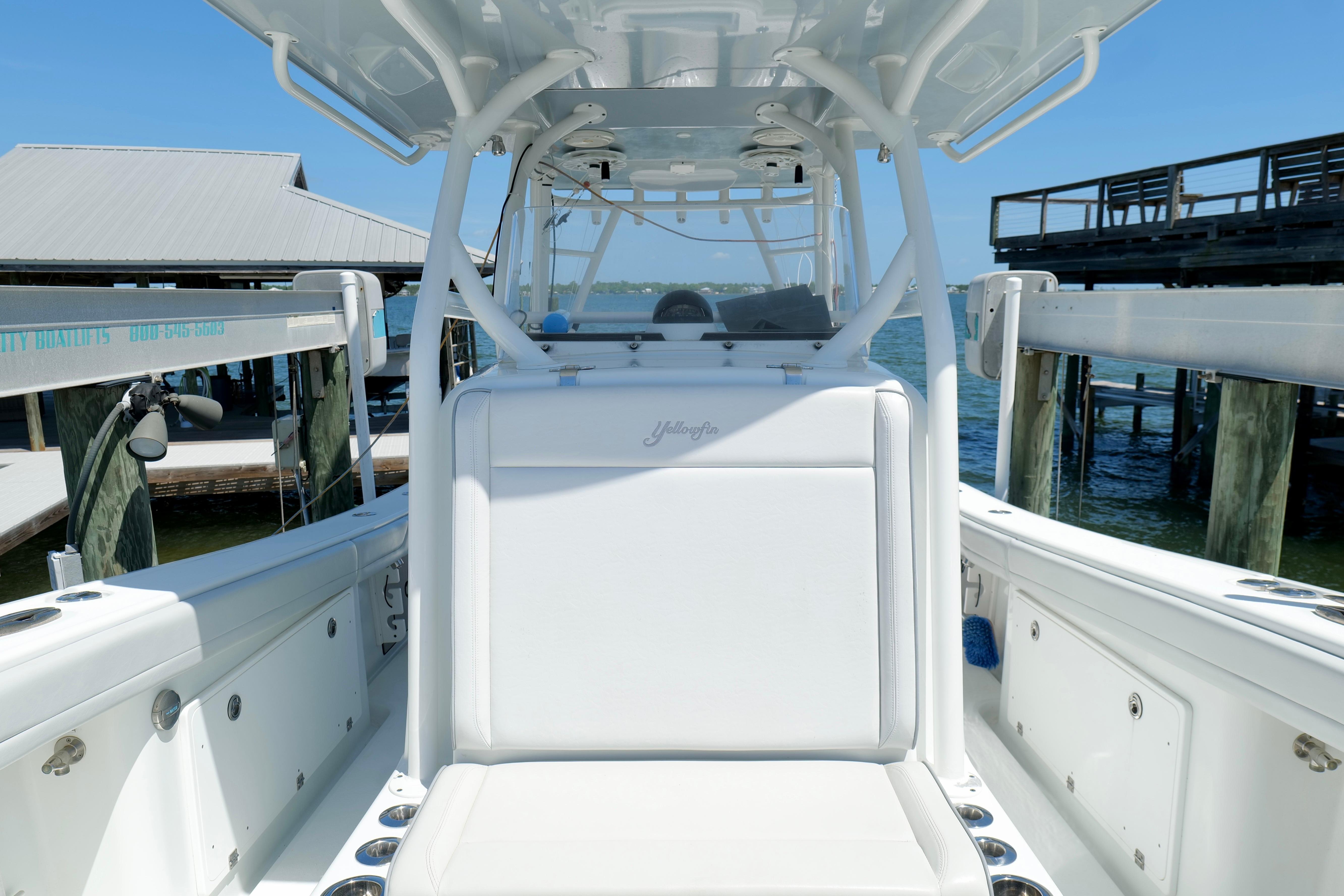 2018 Yellowfin 36 Offshore boat docked, showcasing sleek white seating and spacious deck.