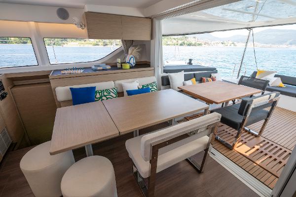 Luxurious interior of 2025 Lagoon 43 yacht with modern dining area and scenic ocean view.