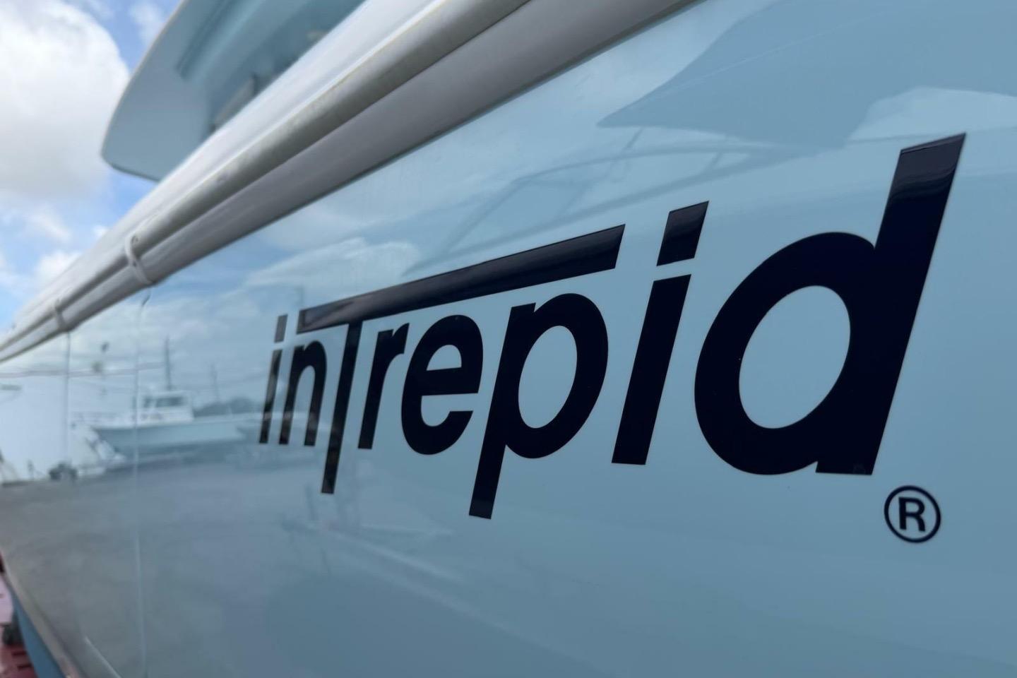 Side view of a 2020 Intrepid 375 Nomad SE boat with logo.