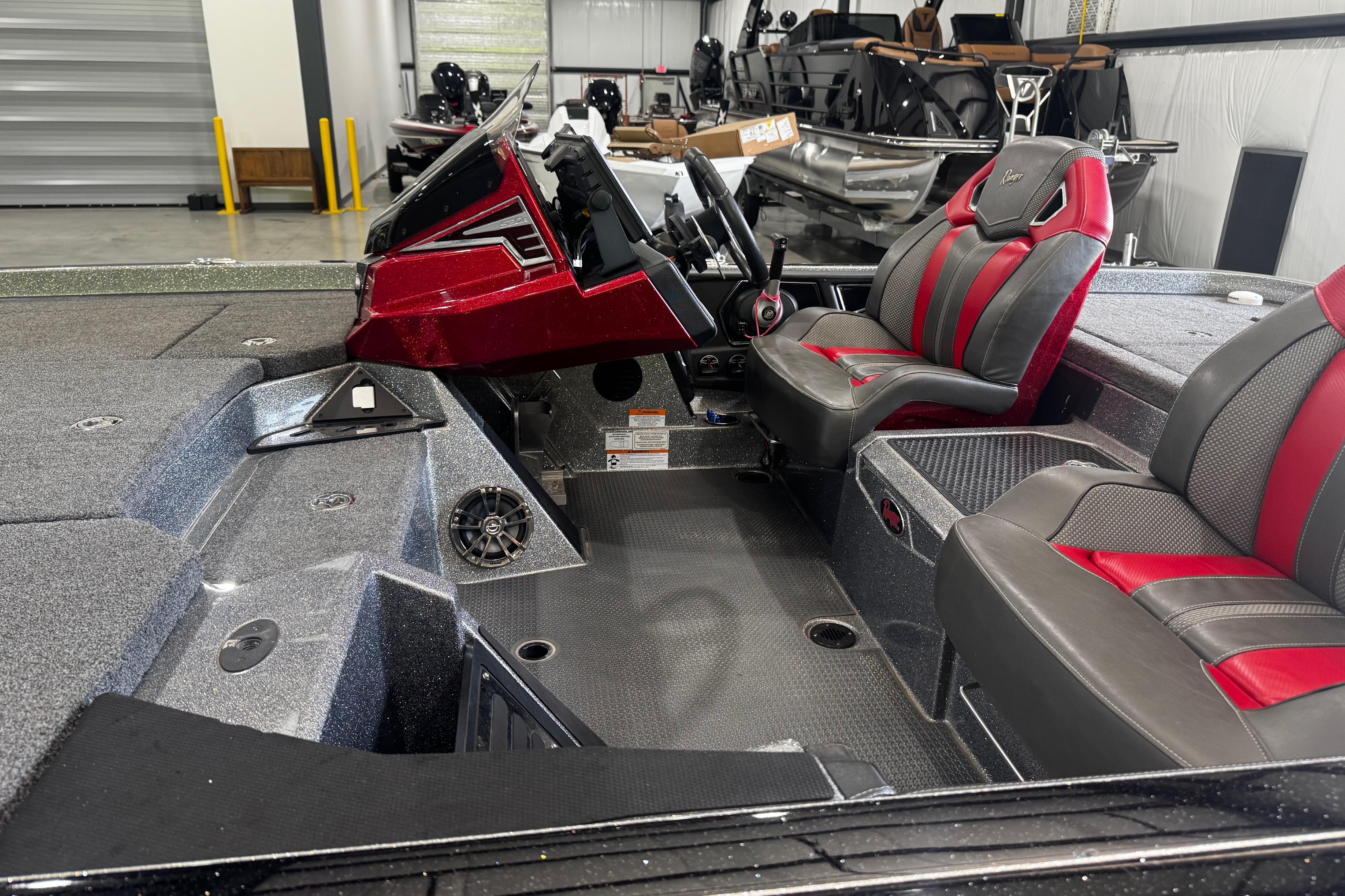 2022 Ranger Z520R boat interior with red and gray seats, steering console, and spacious deck.