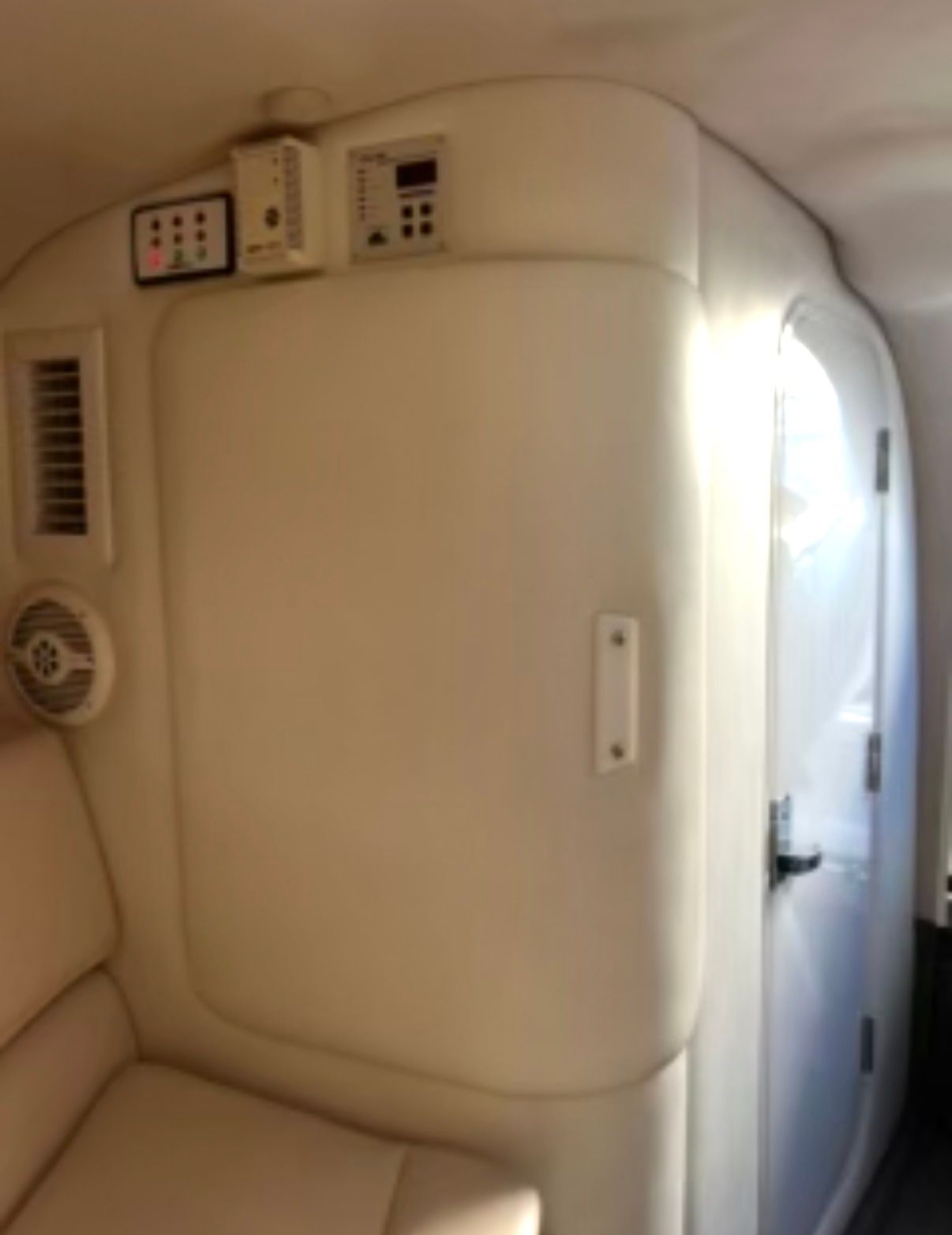 Interior of a 2001 Cobalt 293 with white upholstery and control panels.