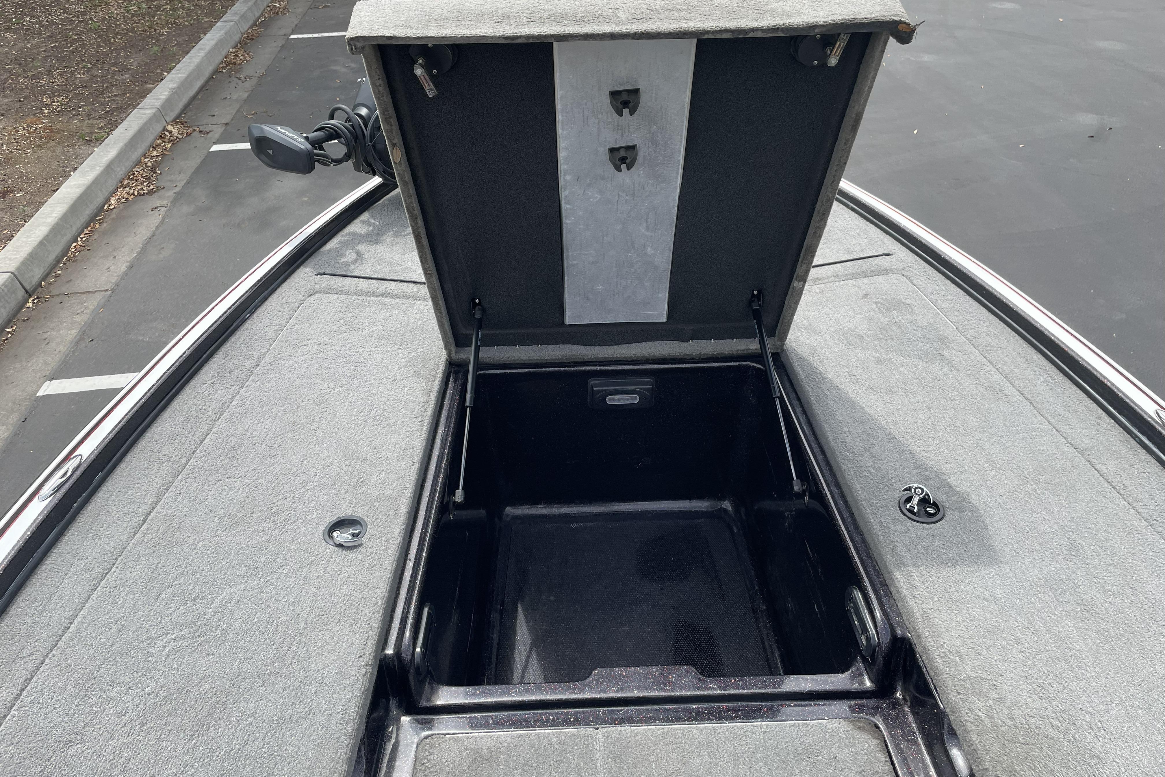Open storage compartment on a 2013 Nitro Z-8 boat, showcasing interior space.