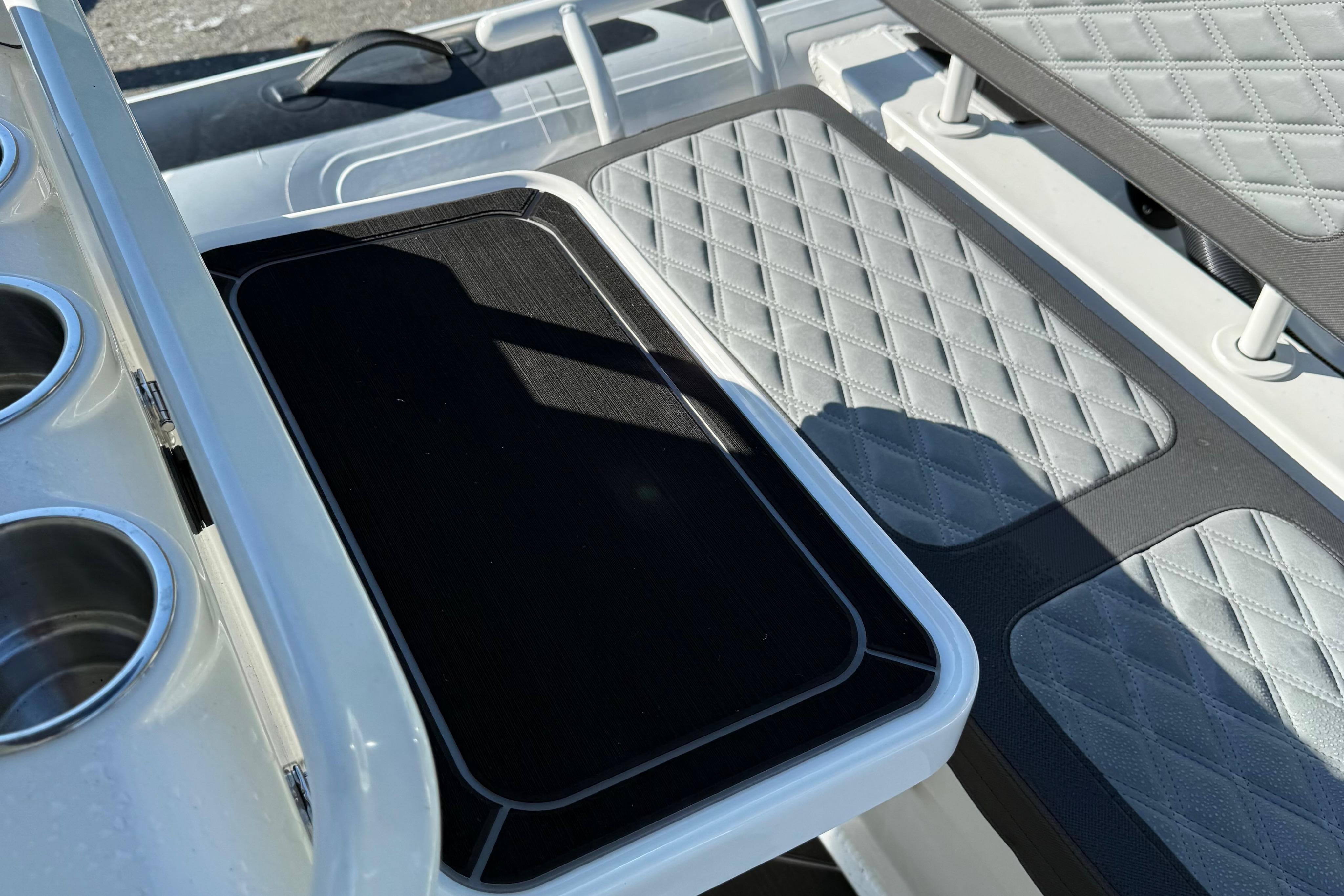 2024 Highfield Sport 560 boat interior with quilted seating and cup holders.