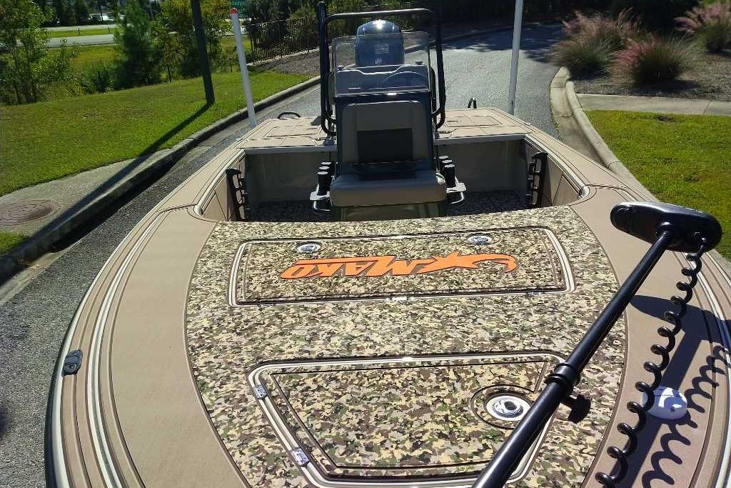 2026 Mako 18 Pro Skiff Backwater Edition boat with camouflage deck and trolling motor.