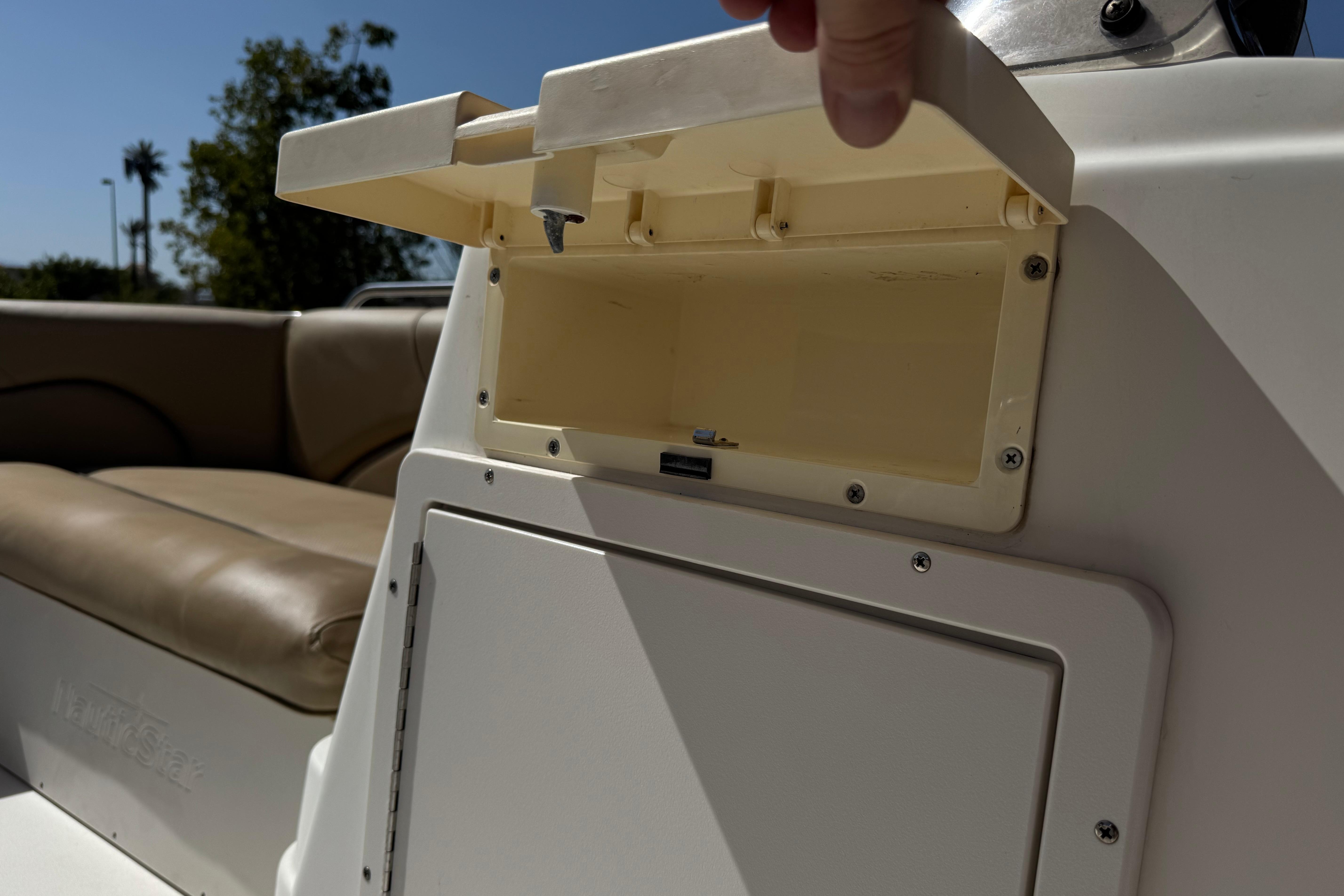 2020 NauticStar 203 SC boat interior with open storage compartment.