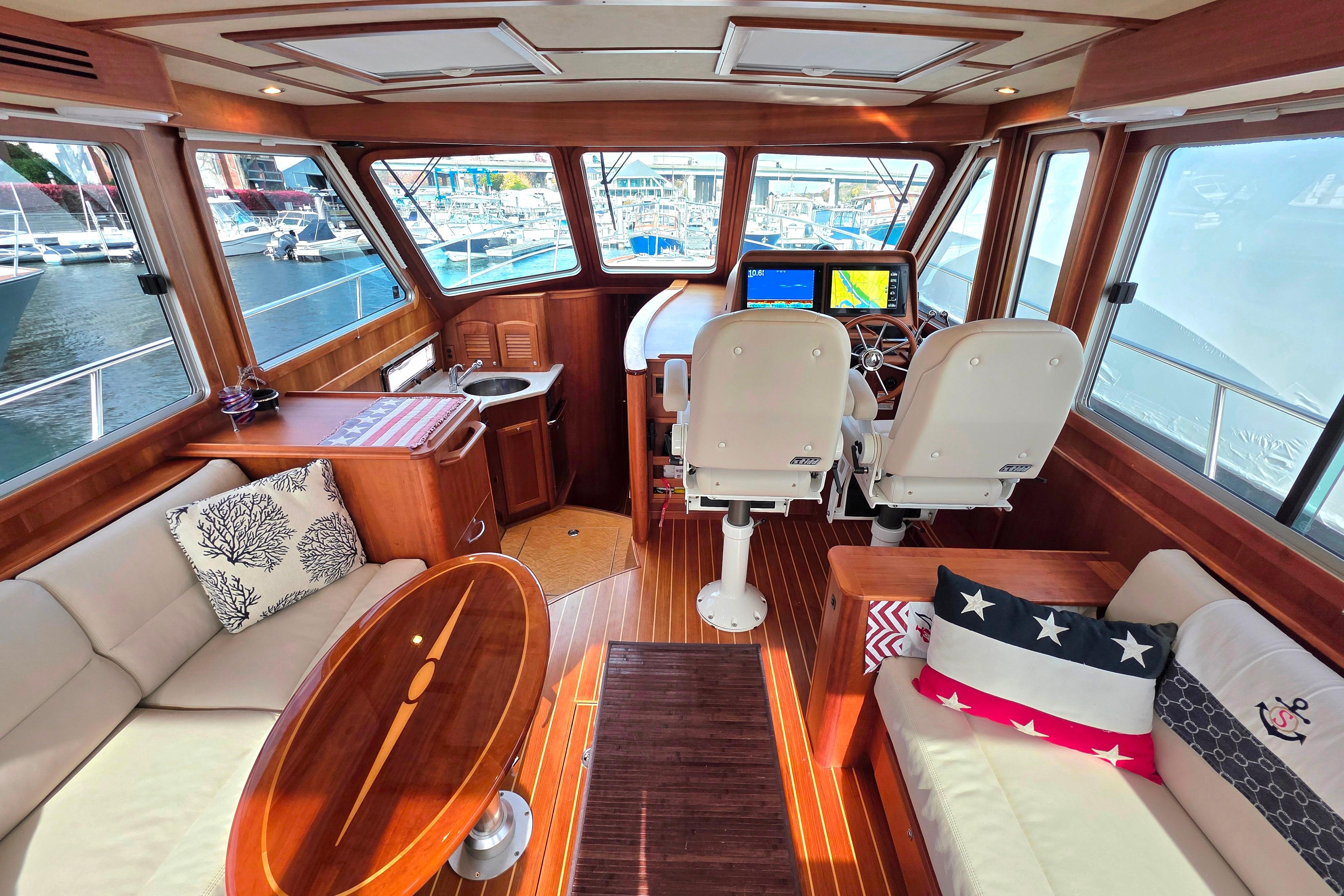 Luxurious 2017 Sabre 42 Salon Express interior with helm, seating, and nautical decor.