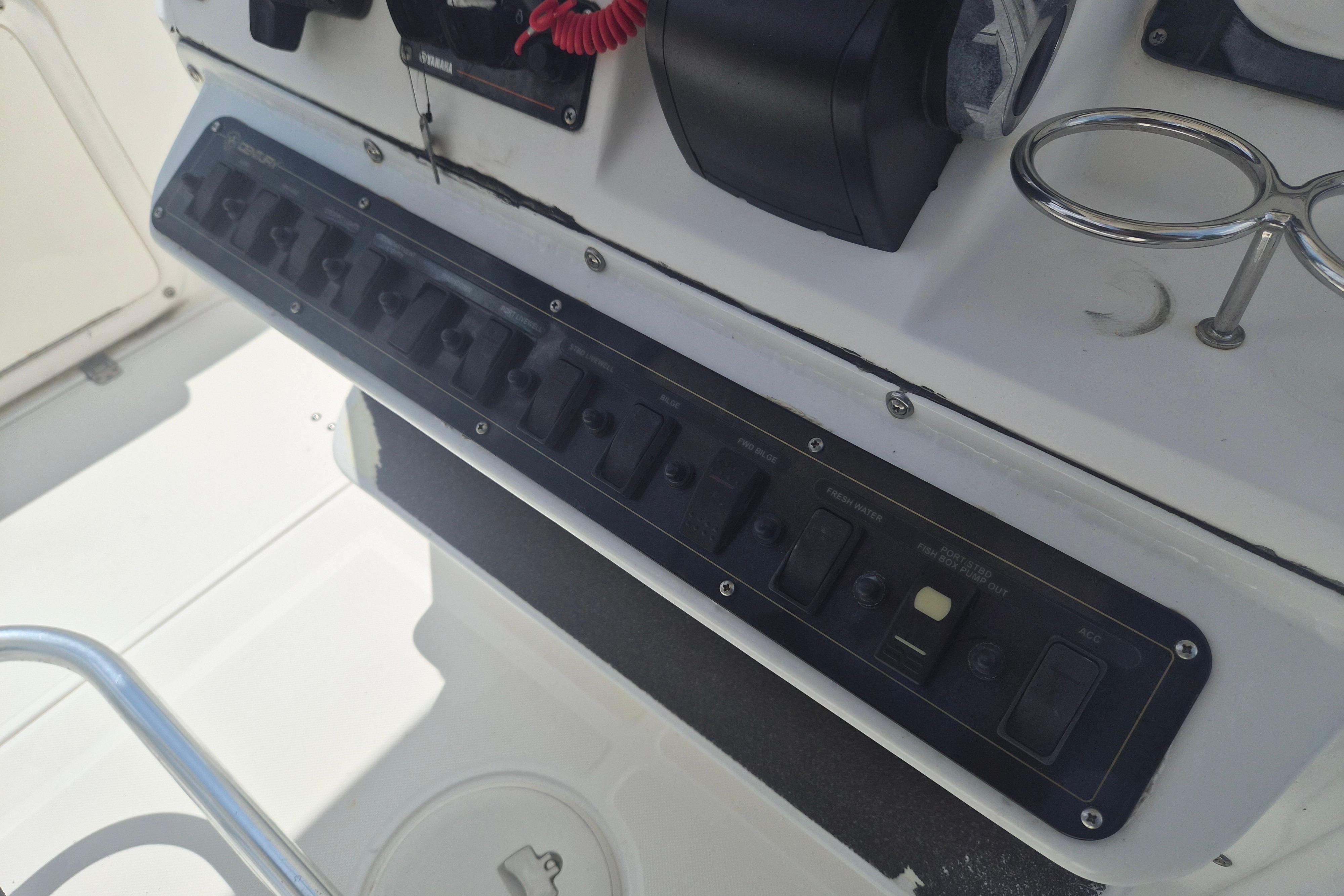 Century 2900 Center Console 2006 boat dashboard with control panel and switches.