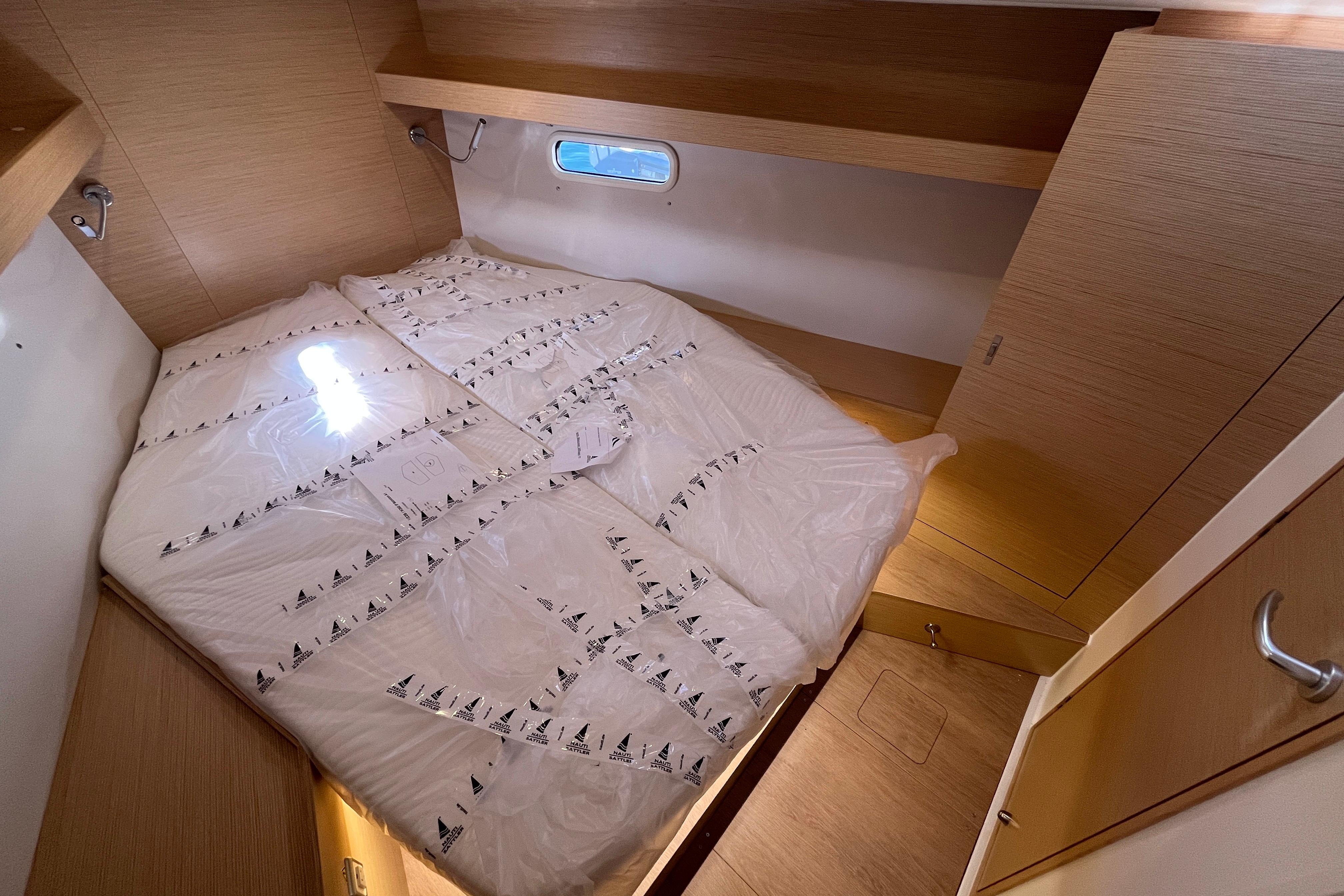 Cozy cabin interior of 2025 Hanse 360 yacht with a neatly made bed.