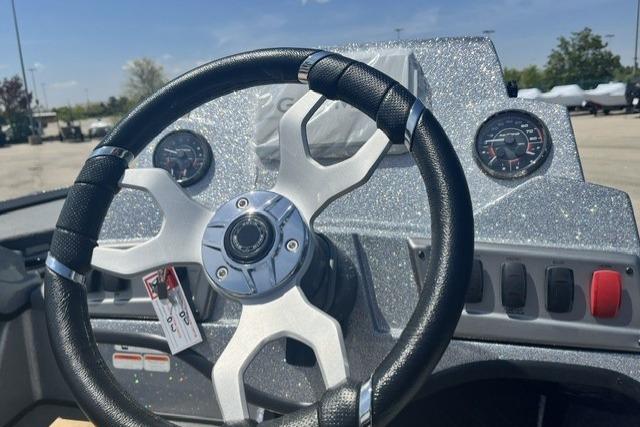 Steering wheel and dashboard of a 2026 Nitro Z18 Pro boat in a parking lot.