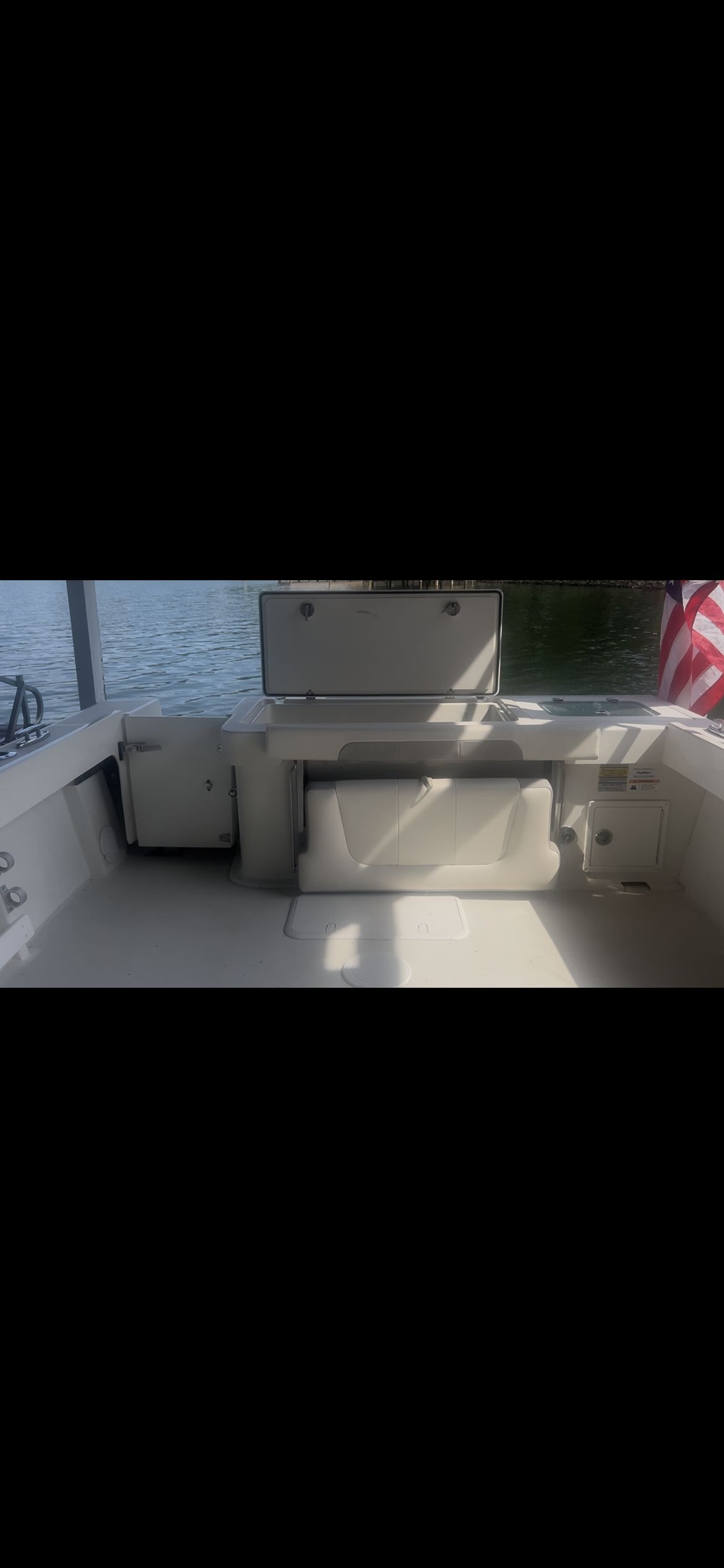 Interior view of a Parker 2320 Sport Cabin boat with seating and storage.