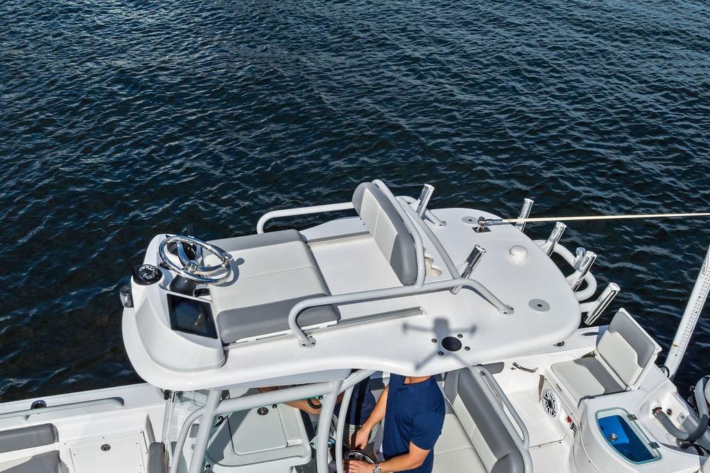 2023 Everglades 243 Center Console boat on water, featuring sleek design and modern controls.