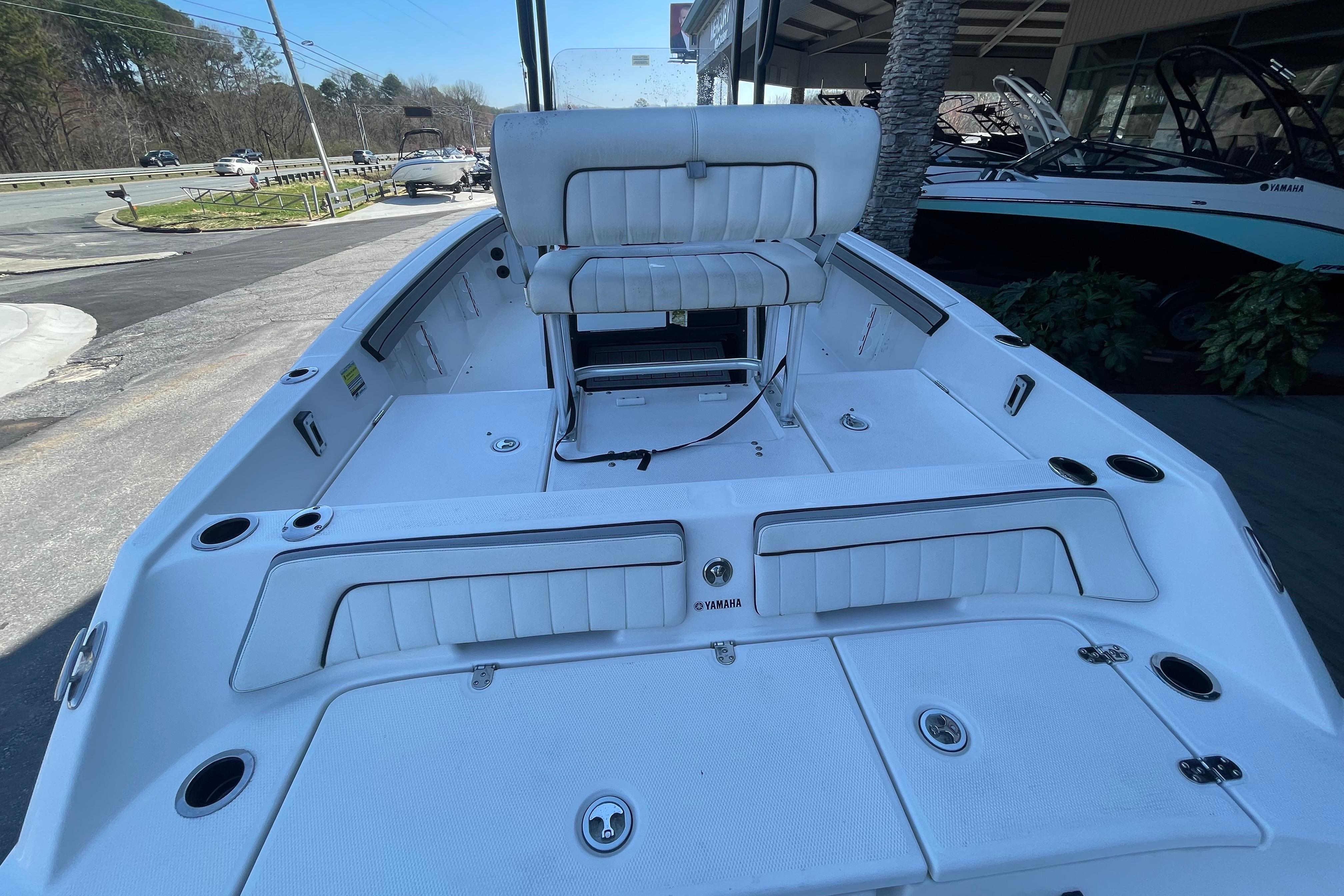 2021 Yamaha Boats 195 FSH Sport interior, featuring white seating and storage compartments.