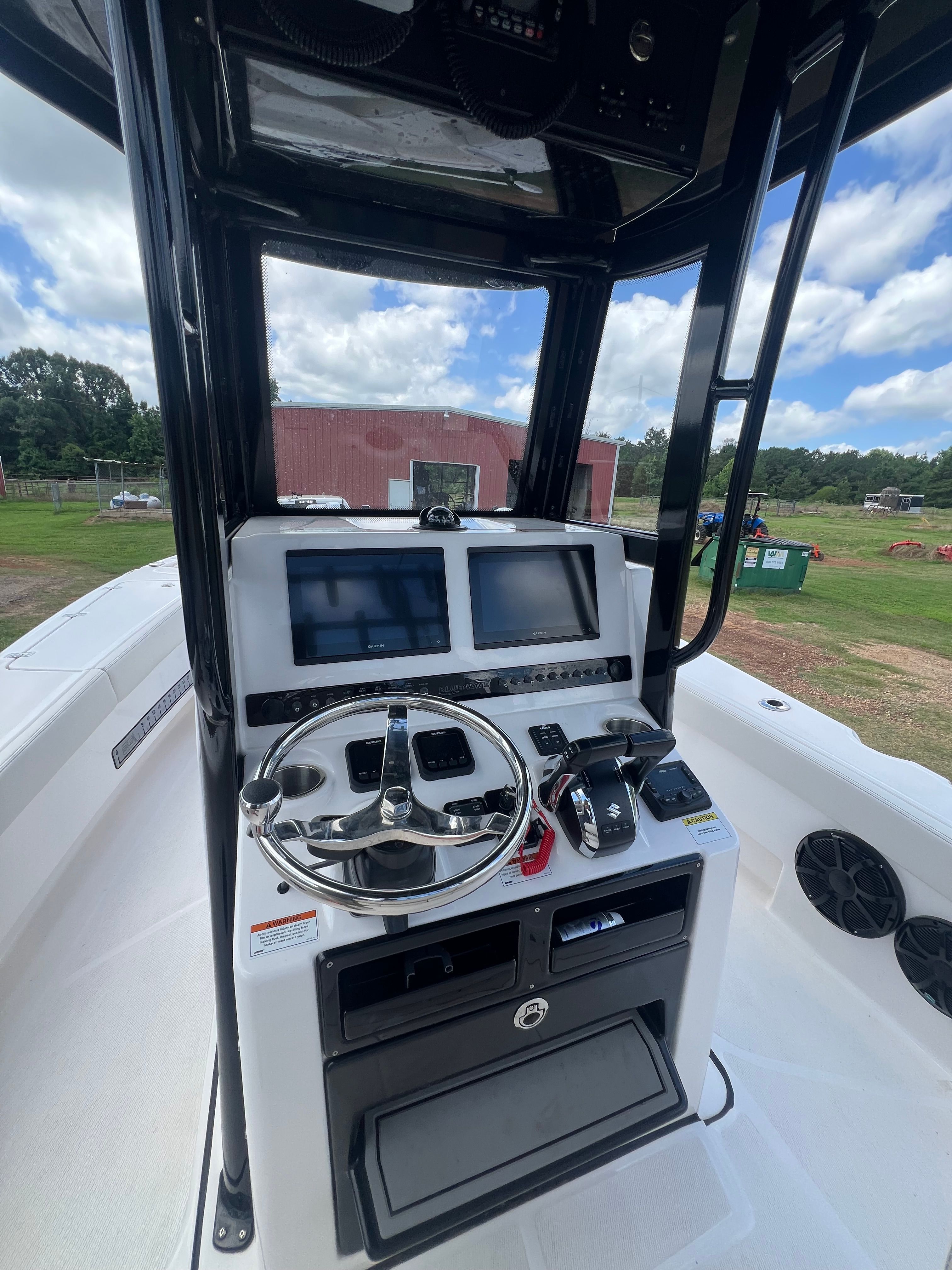 Helm of the 2023 Blue Wave 2800 Makaira with modern instruments and steering wheel.