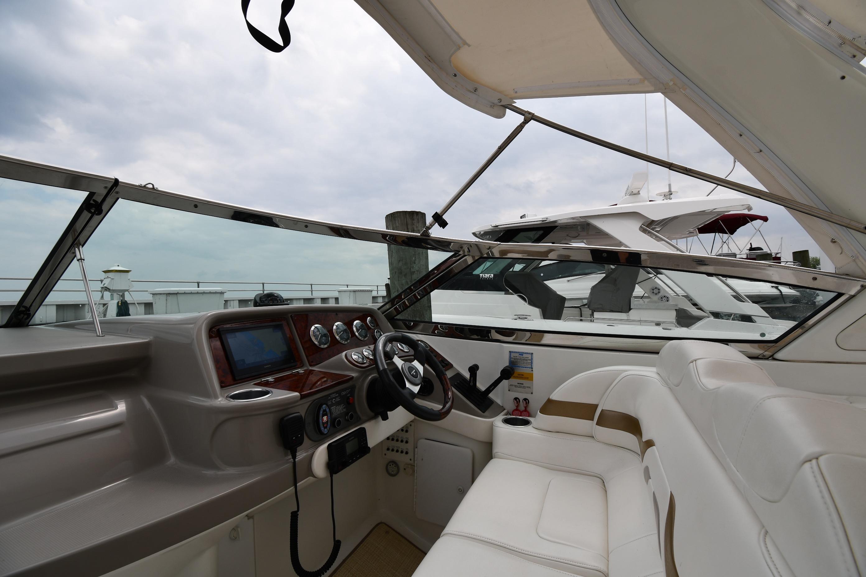 2004 Formula 330 Sun Sport boat interior with steering wheel and dashboard controls.