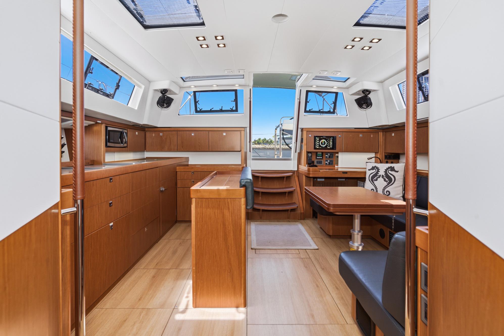 Luxurious interior of 2017 Beneteau Sense 50 yacht with modern wood finish.