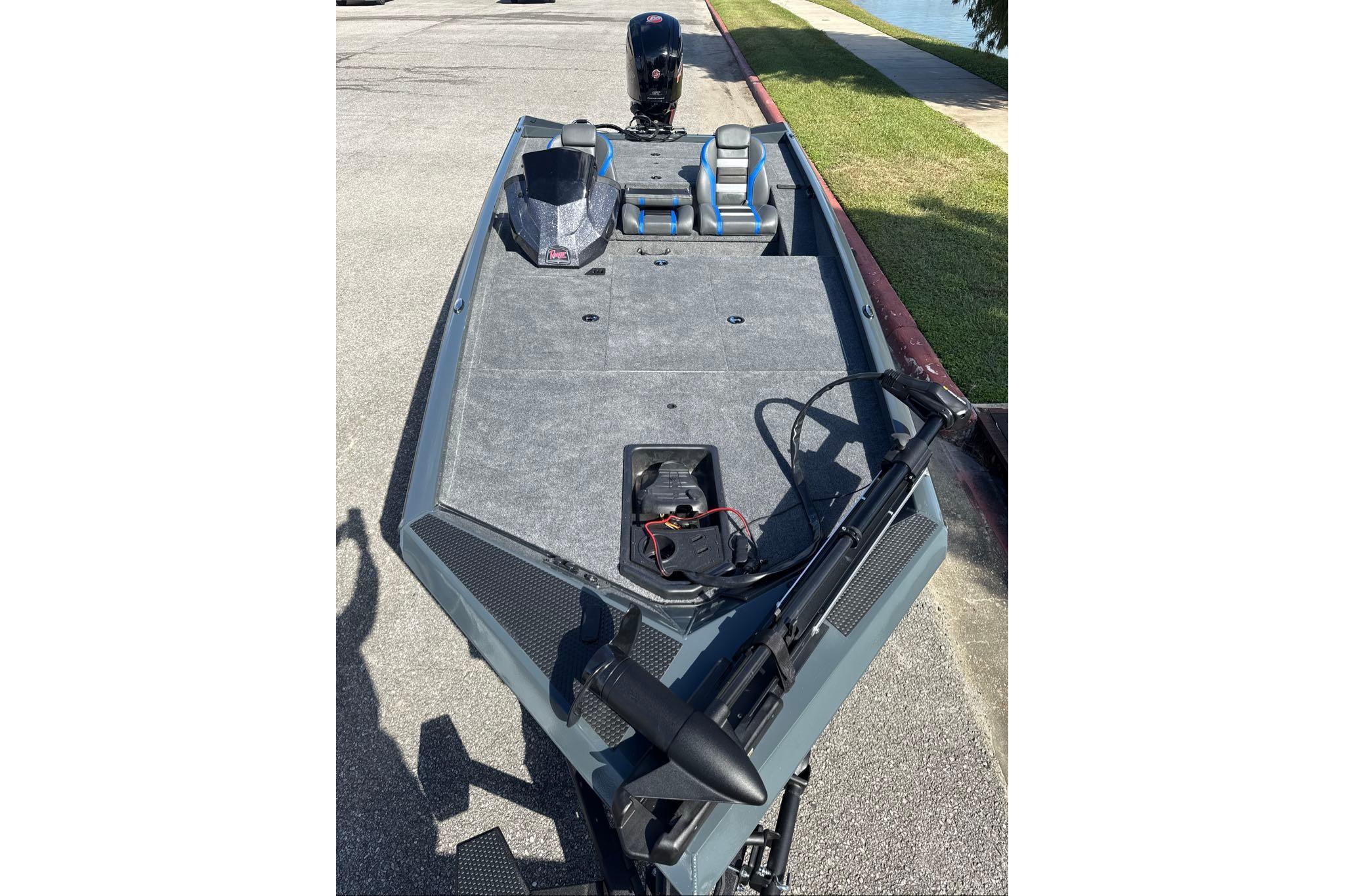 2026 Ranger RT188 fishing boat with trolling motor, parked on pavement near water.