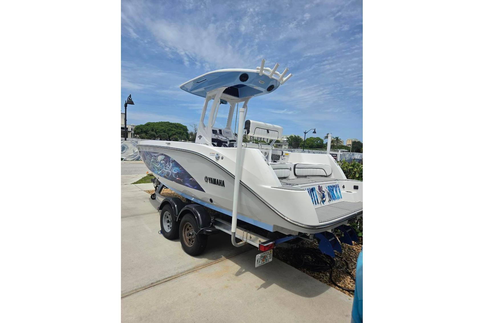 2024 Yamaha Boats 222 FSH Sport E on trailer, showcasing sleek design and modern features.