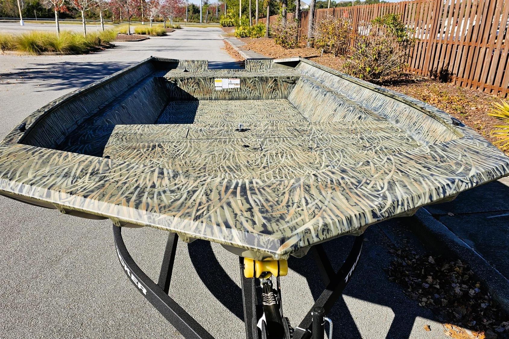 2026 Tracker Grizzly 2072 Utility boat with camouflage design on a trailer.