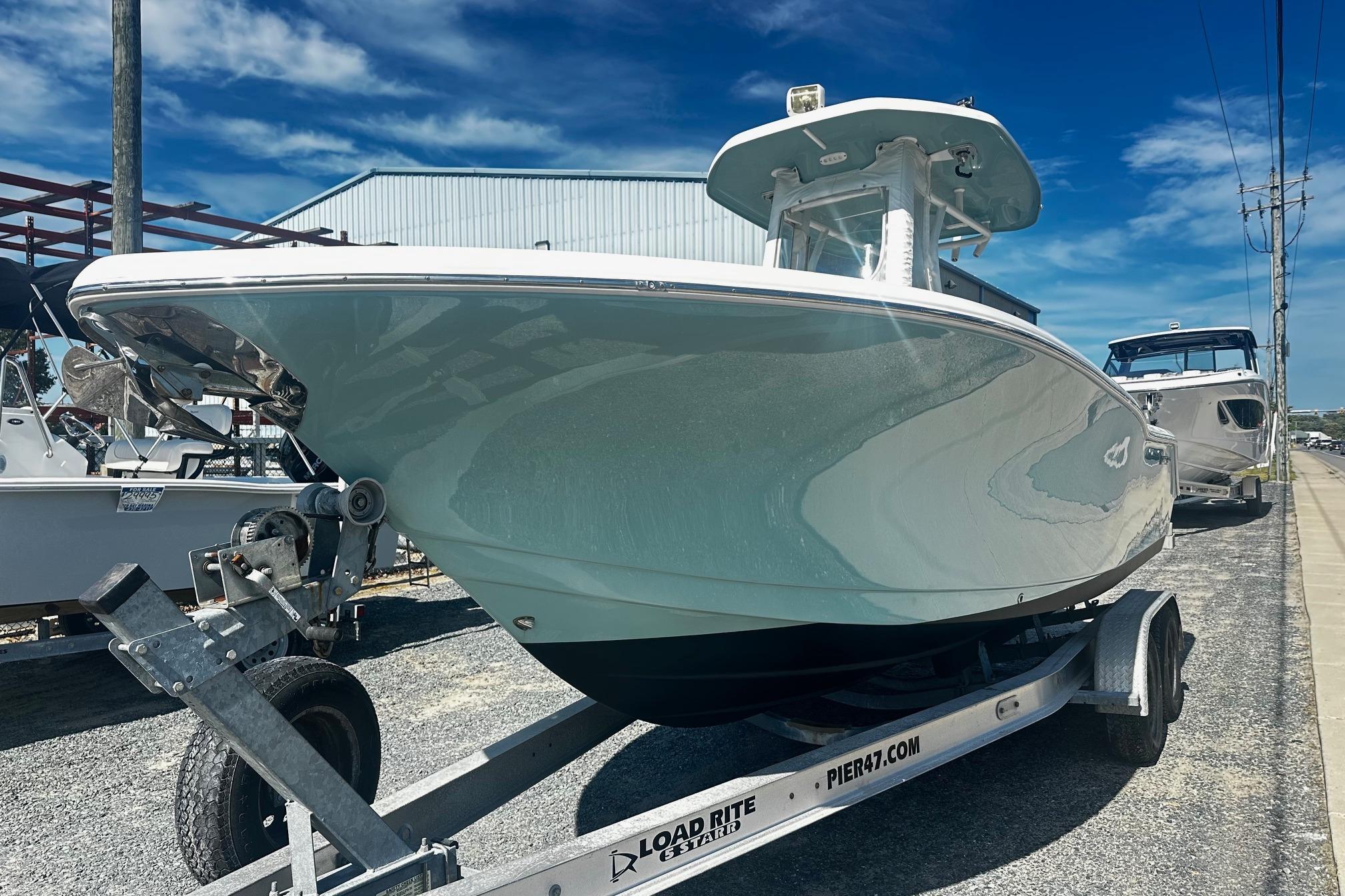 2020 Tidewater 230 CC Adventure boat on trailer under clear blue sky.
