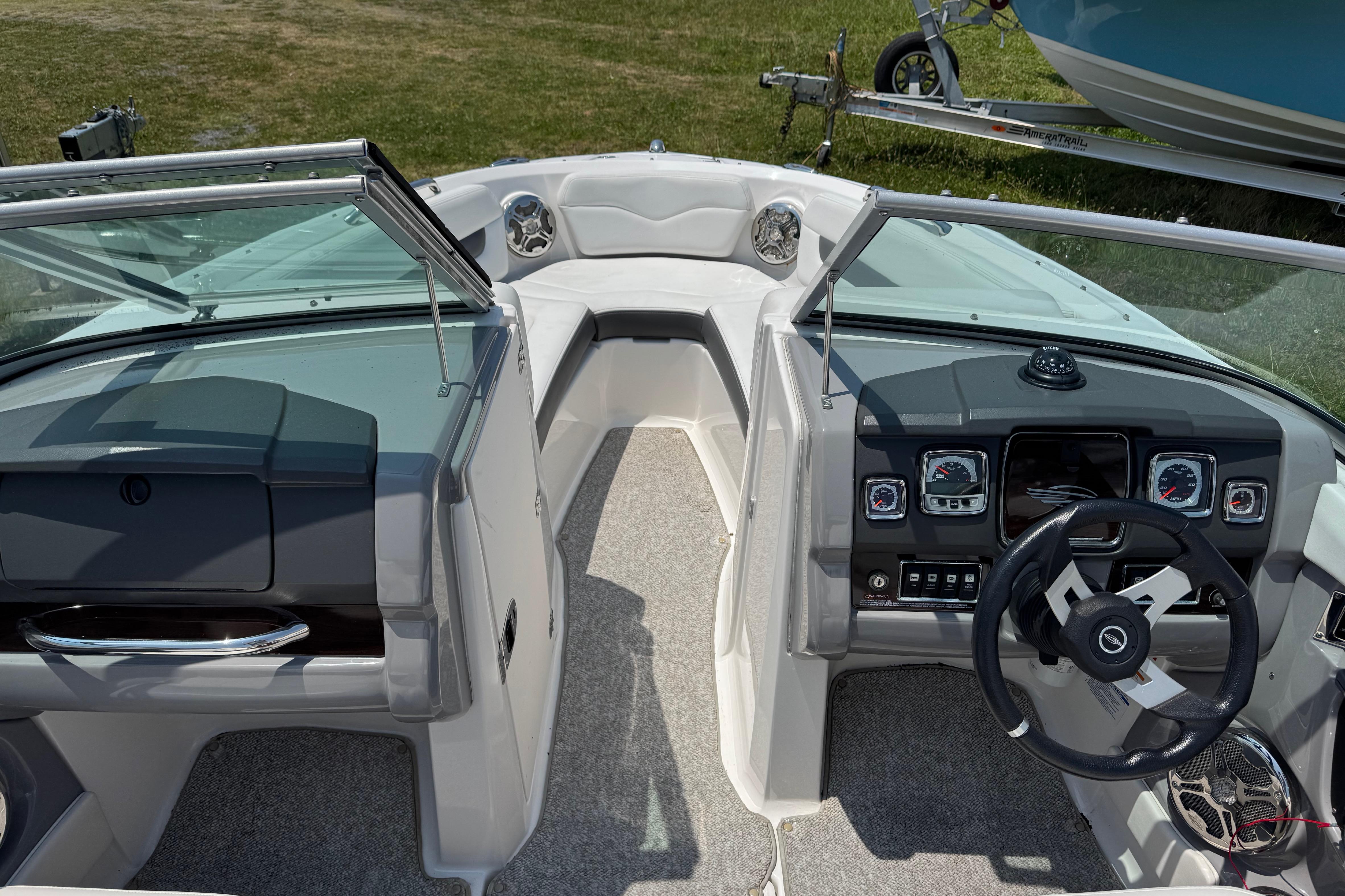 Interior view of 2013 Chaparral 196 SSi boat cockpit with steering wheel and dashboard.