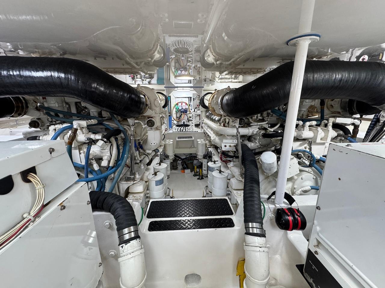 Engine room of a 2007 Viking 52 Convertibles yacht, showcasing complex machinery and piping.